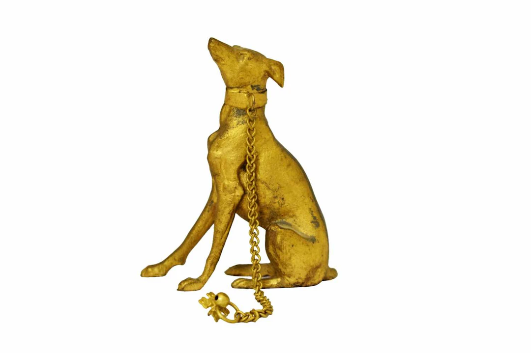 Small gilt metal seated greyhound