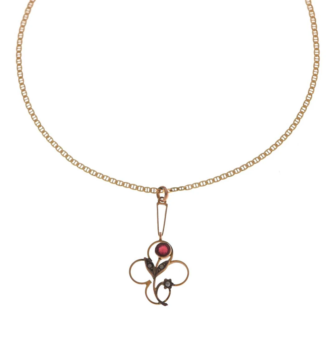 Garnet and seed pearl yellow metal floral pendant, stamped '9ct'