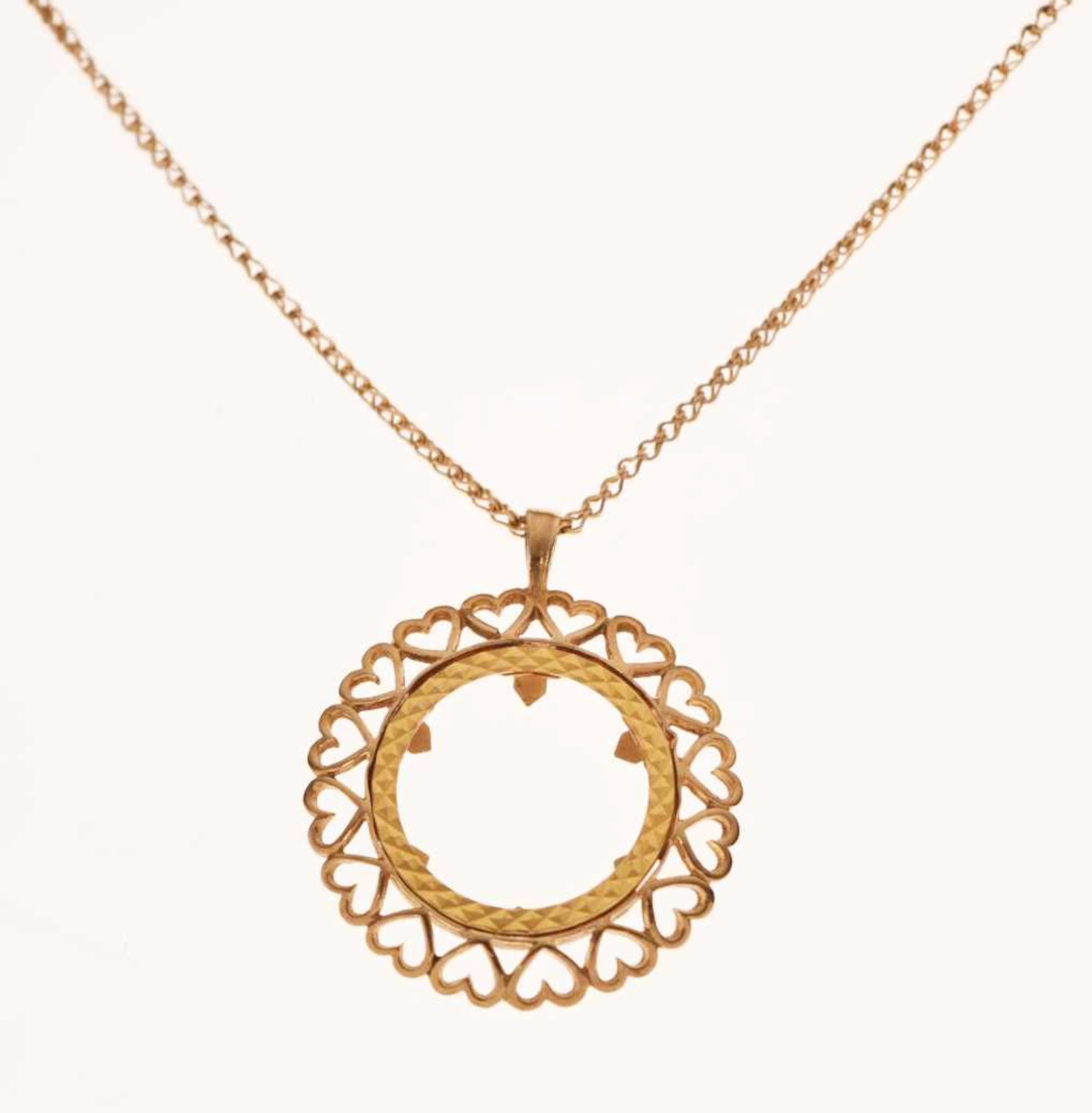 9ct gold half sovereign mount, on a 9ct gold curb link chain