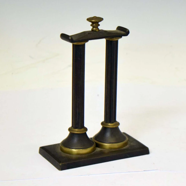 Early 20th century bronze watch stand in the form of two classical pillars