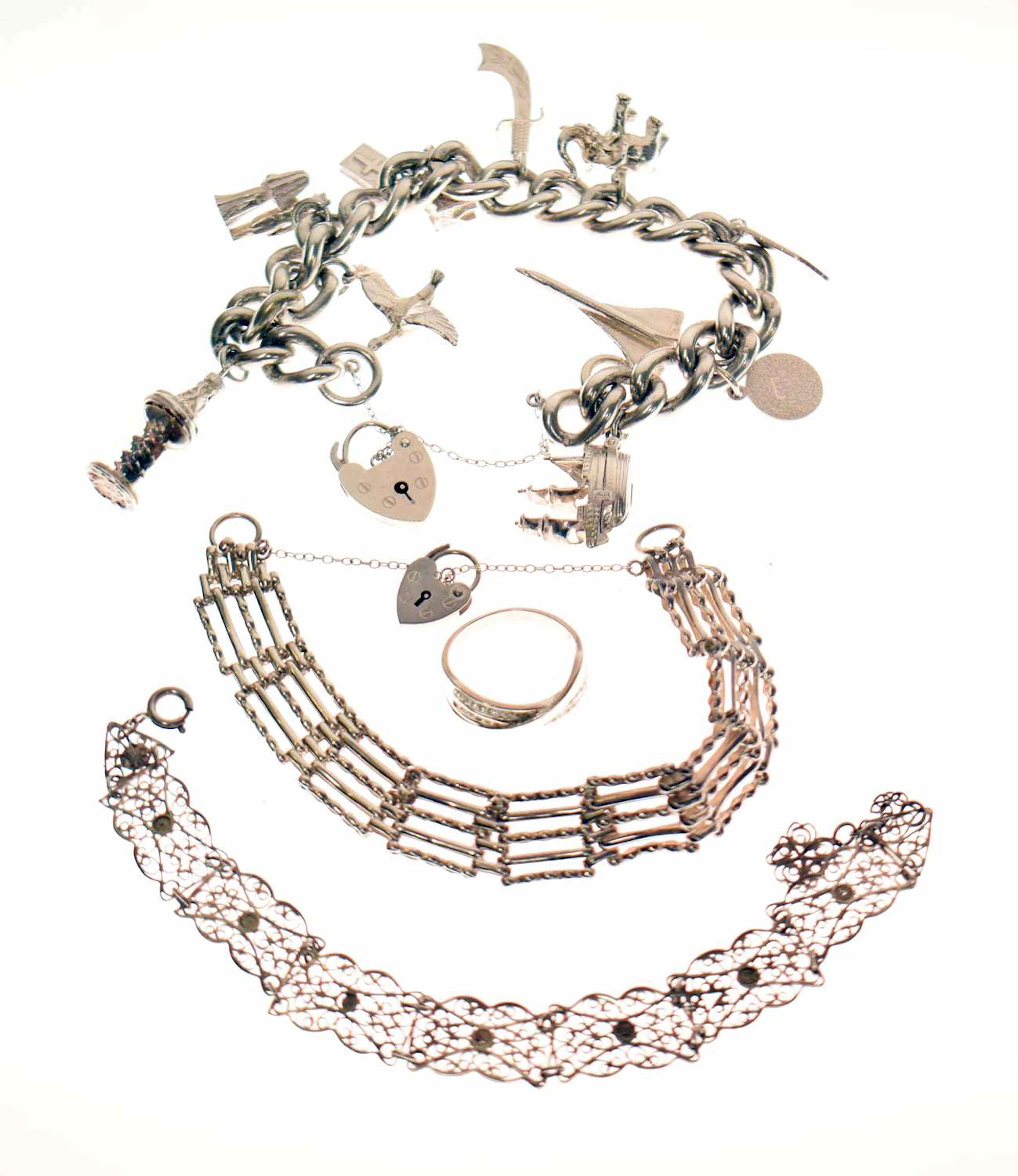 Silver curb link charm bracelet, two other bracelets, and a ring (4)