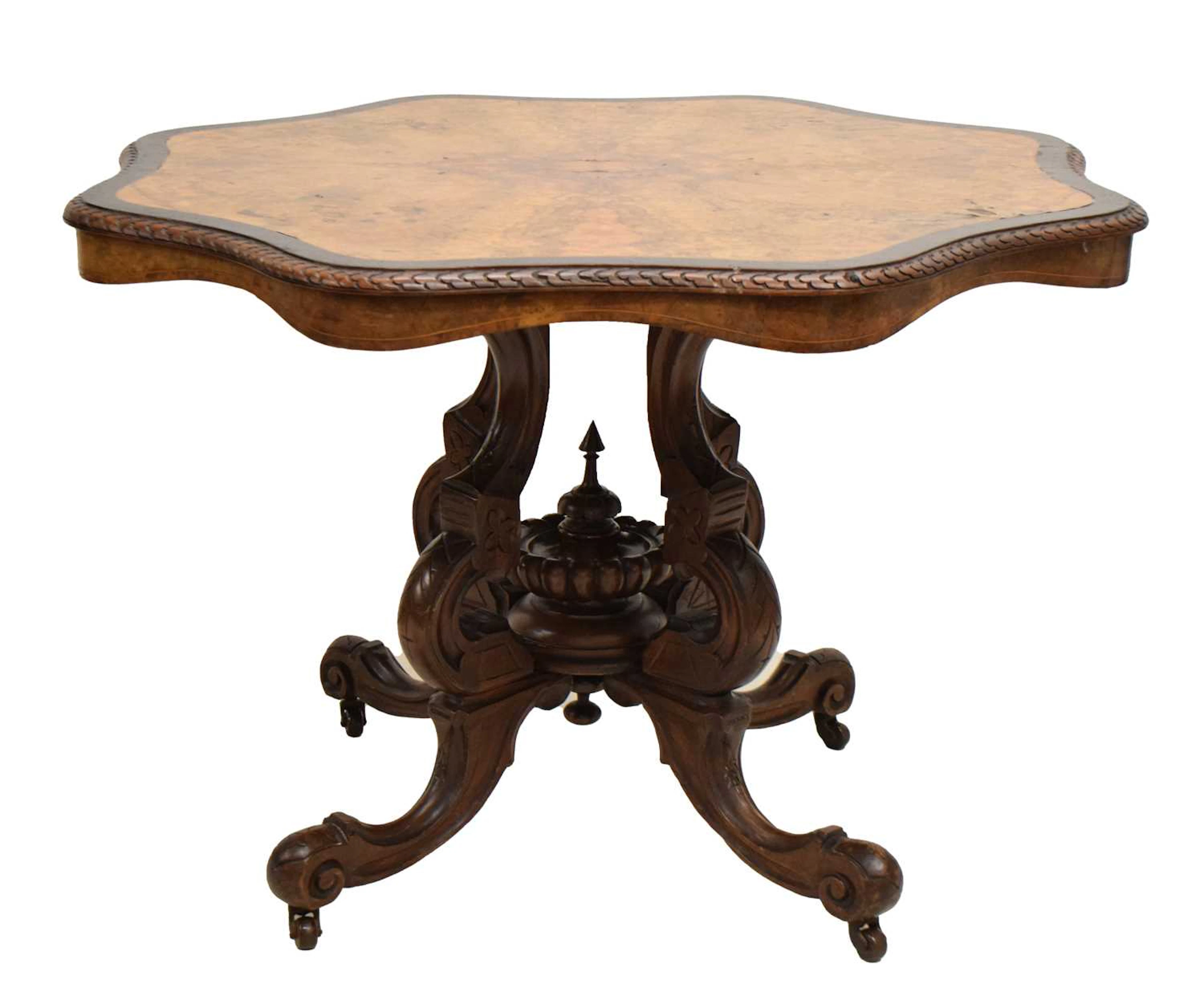 Mid Victorian figured walnut and ebonised centre table