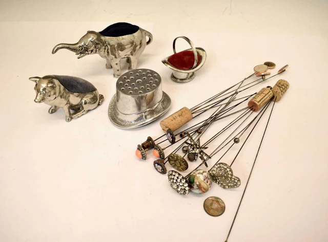 Four novelty hat pin holders, together with a collection of early