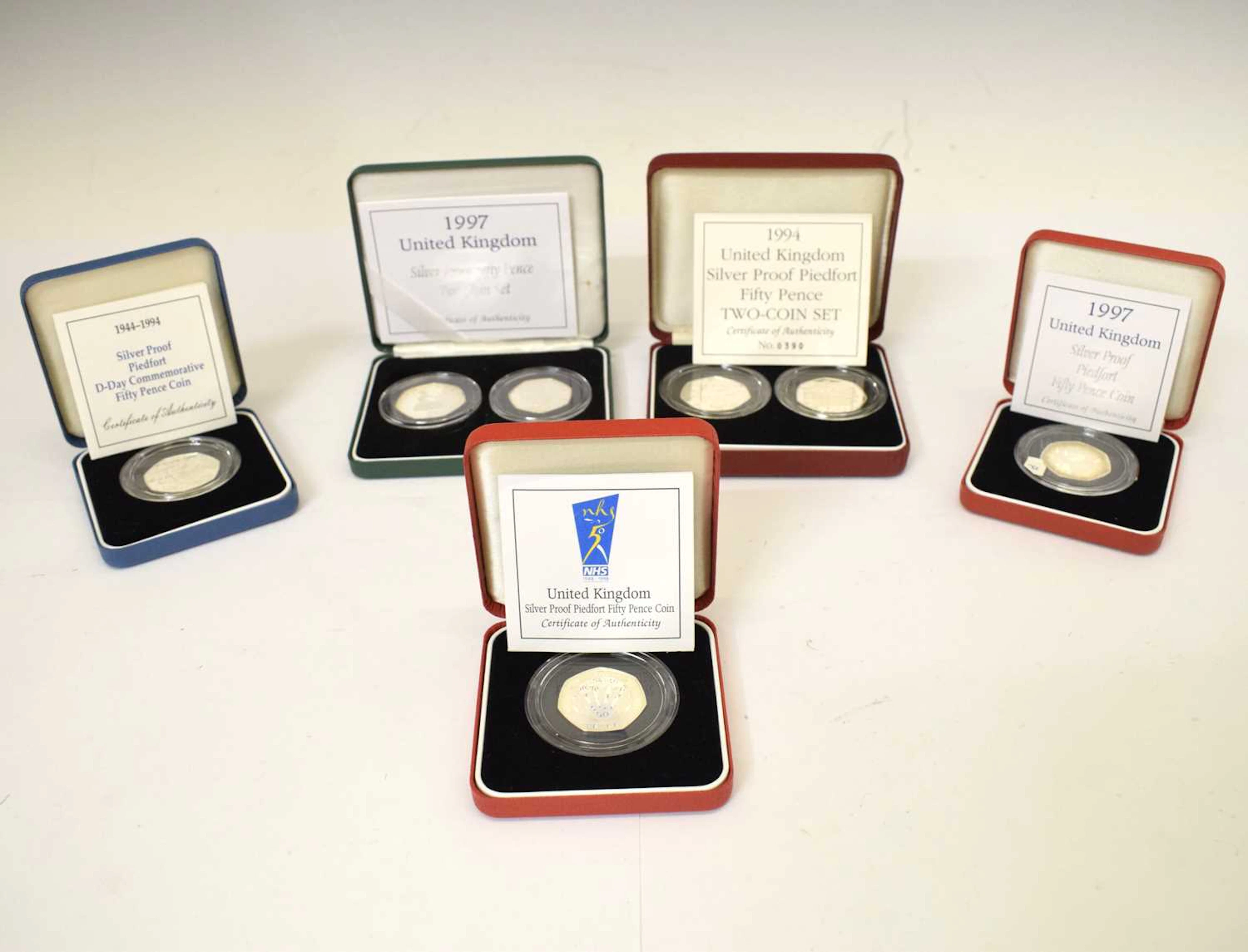 Five Elizabeth II GB silver Proof 50p coin sets