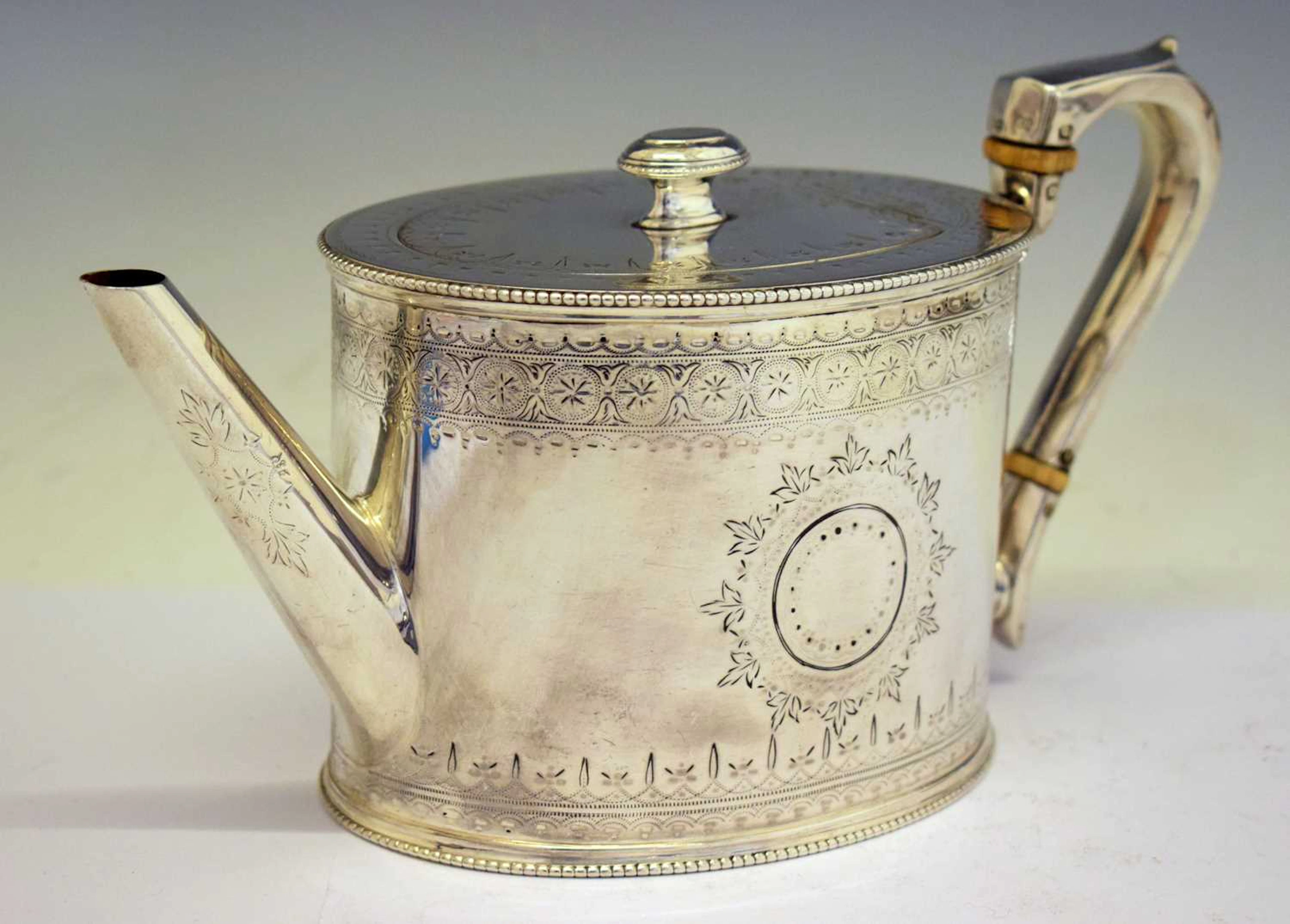 Victorian silver teapot of oval form with bright-cut decoration