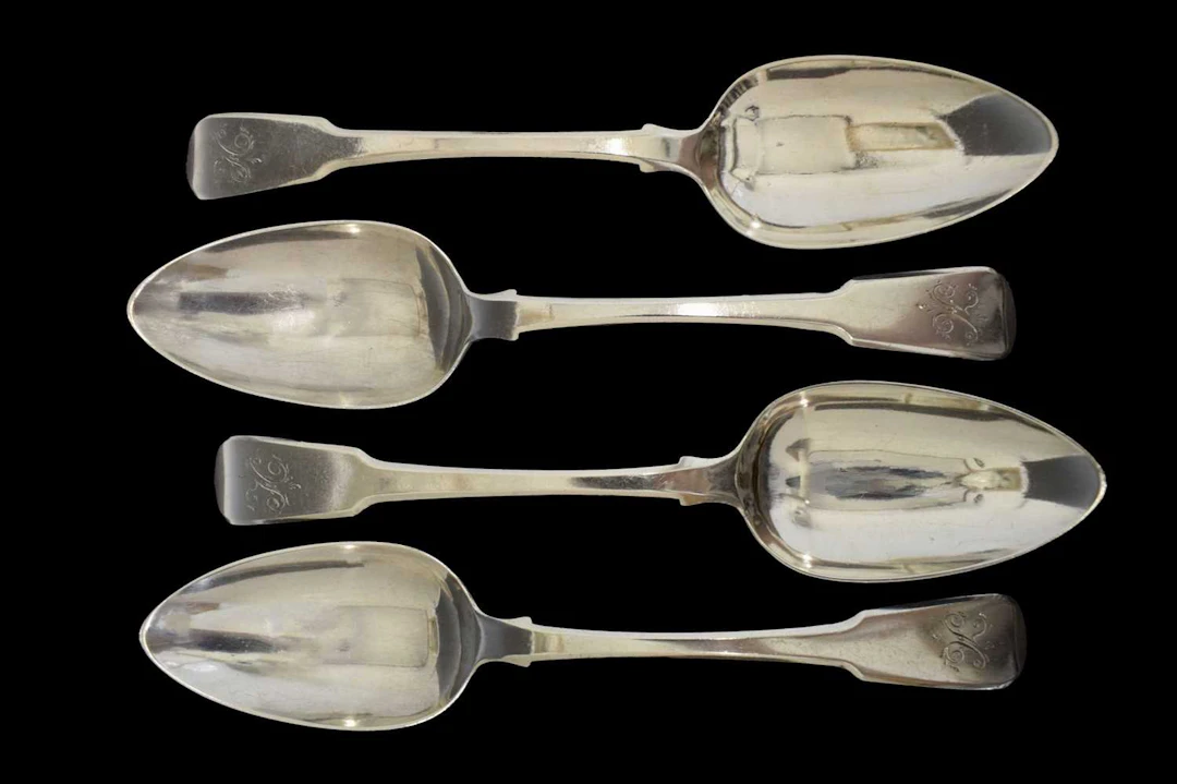 Set of four George III silver Fiddle pattern table spoons