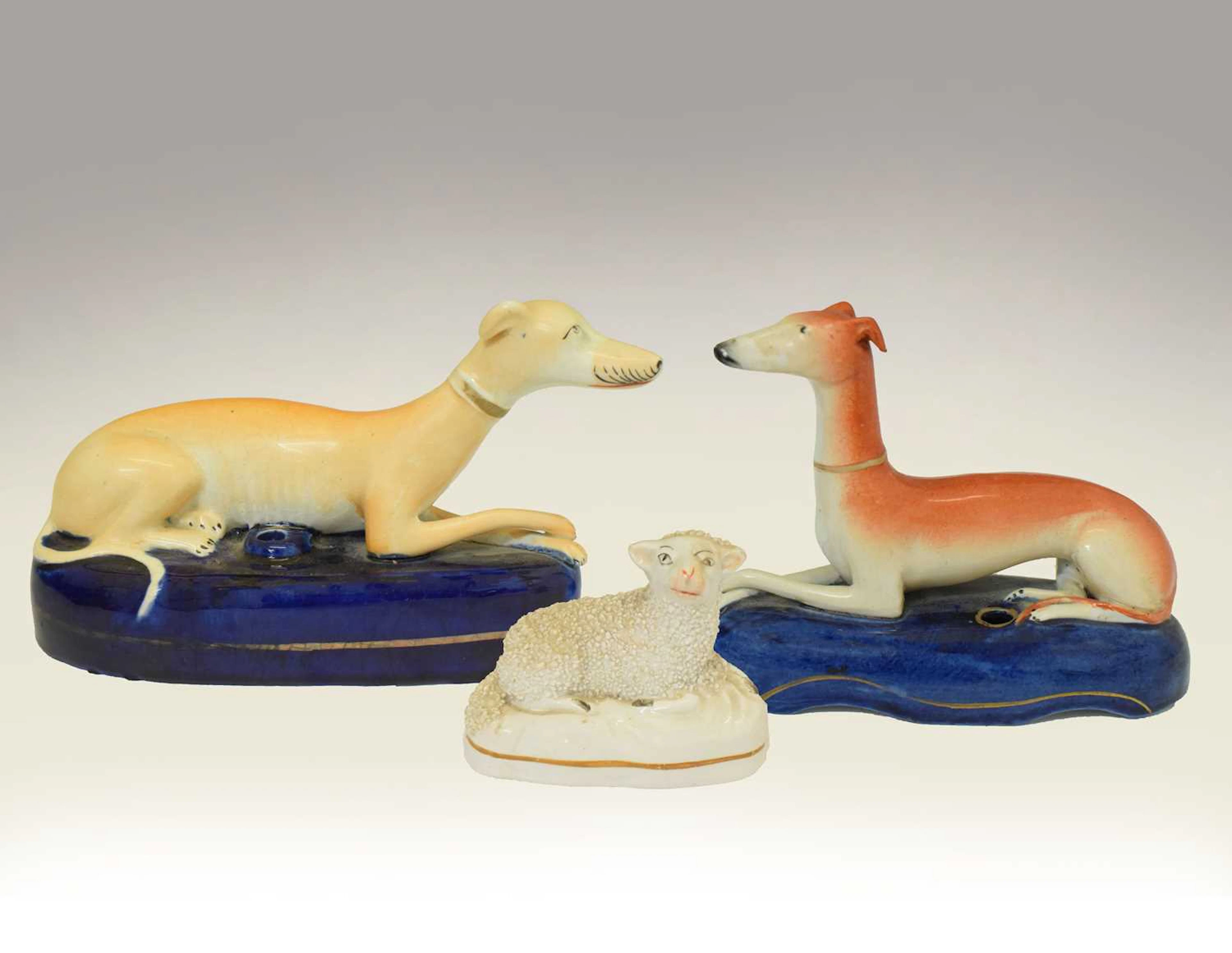 Two 19th century Staffordshire Greyhound pen holders and a Staffordshire sheep