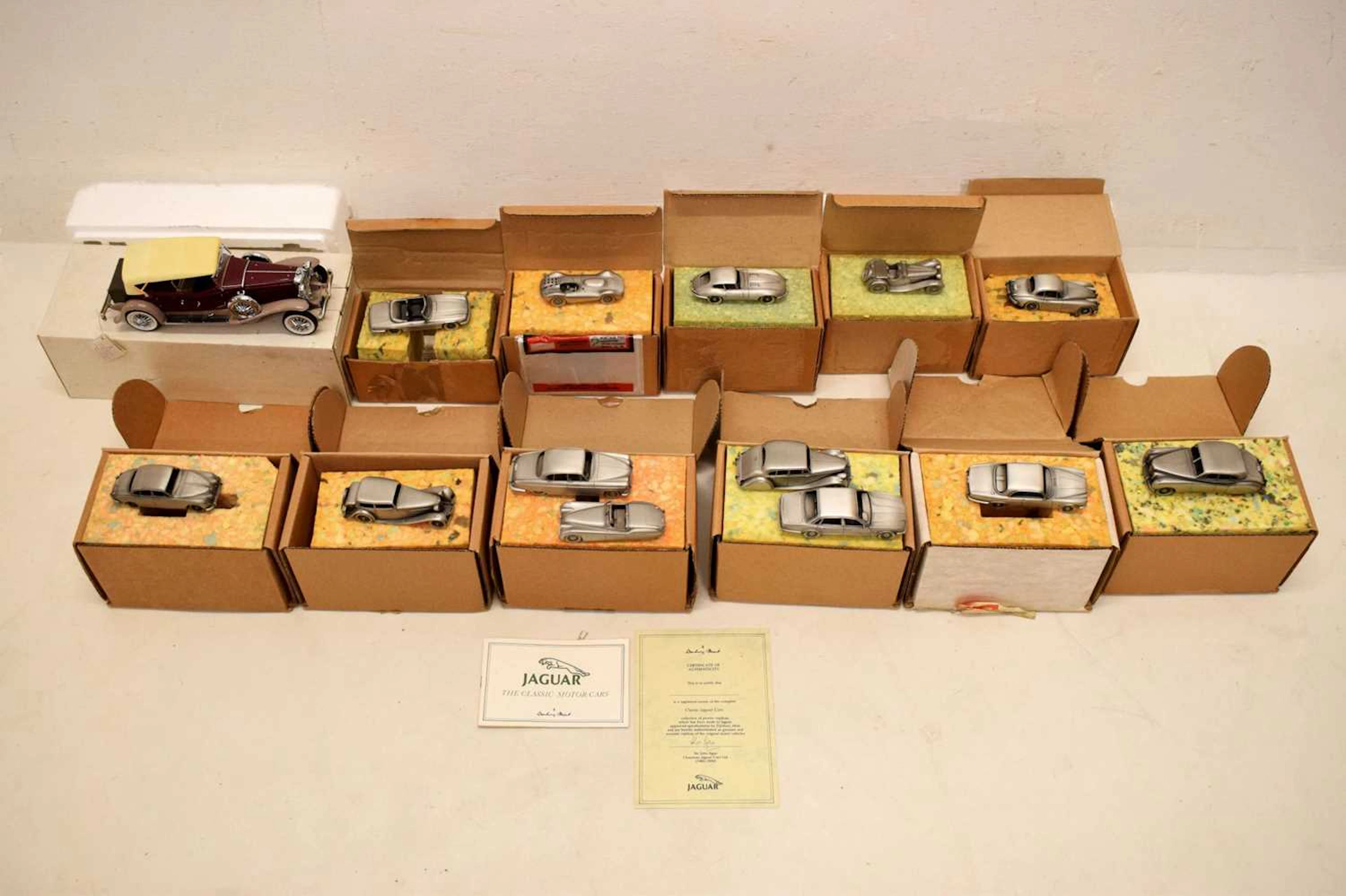Thirteen Danbury Mint pewter Jaguar model vehicles