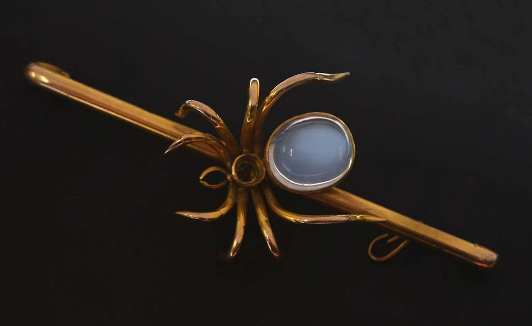 Antique moonstone and yellow metal spider bar brooch (a/f)