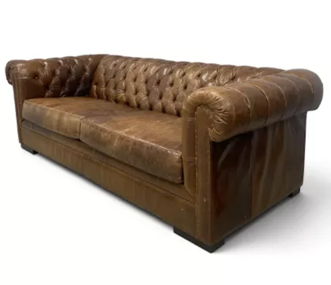 A contemporary brown leather upholstered chesterfield sofa with two