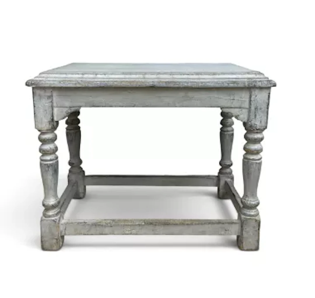 A distressed painted console table in the Jacobean style with plank