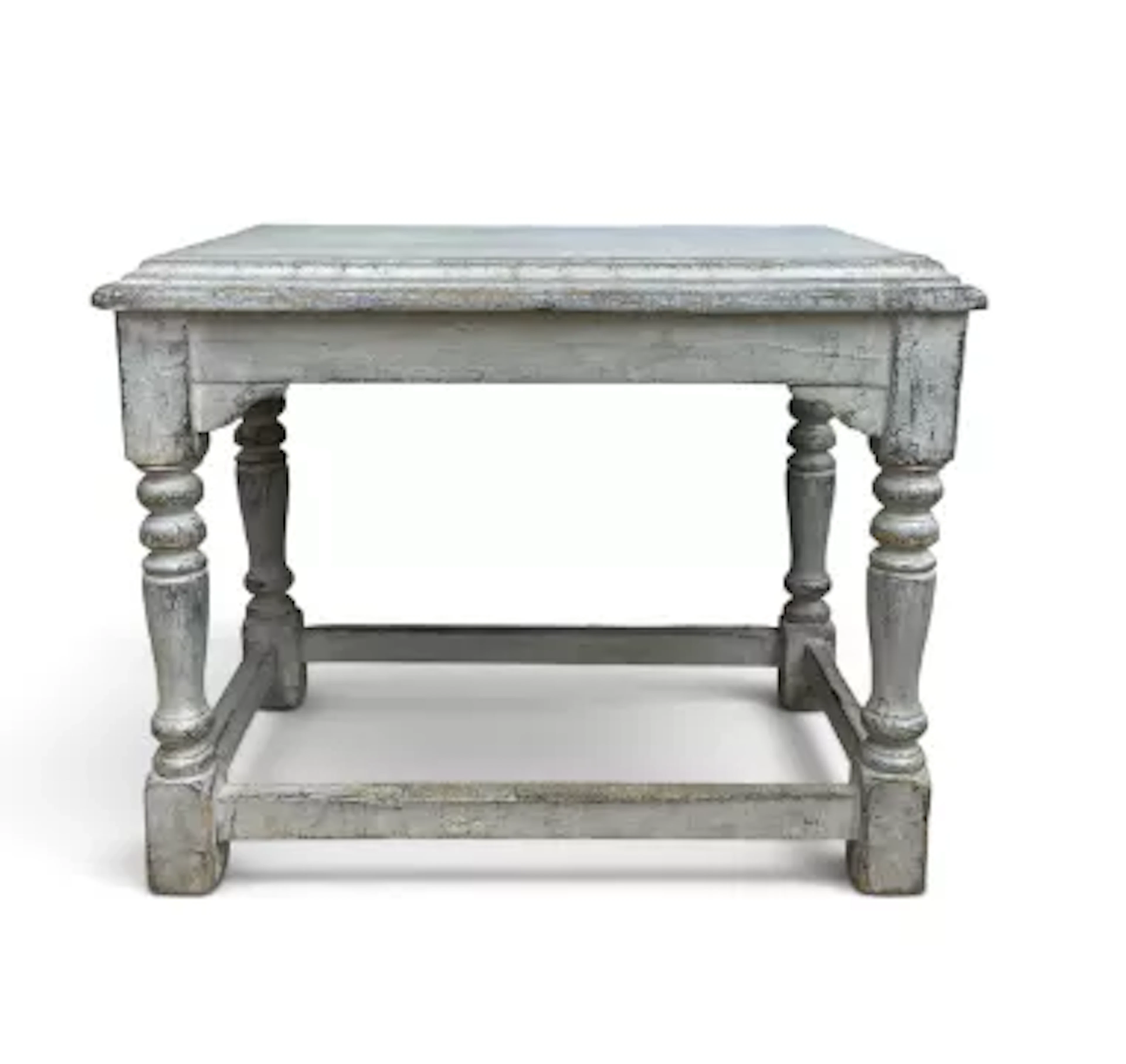 A distressed painted console table in the Jacobean style with plank