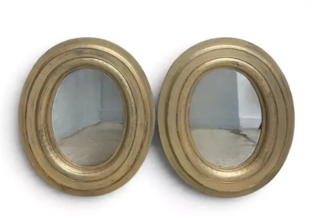 A pair of contemporary oval wall hanging mirrors in gilt frames. H.92 x W.78cm