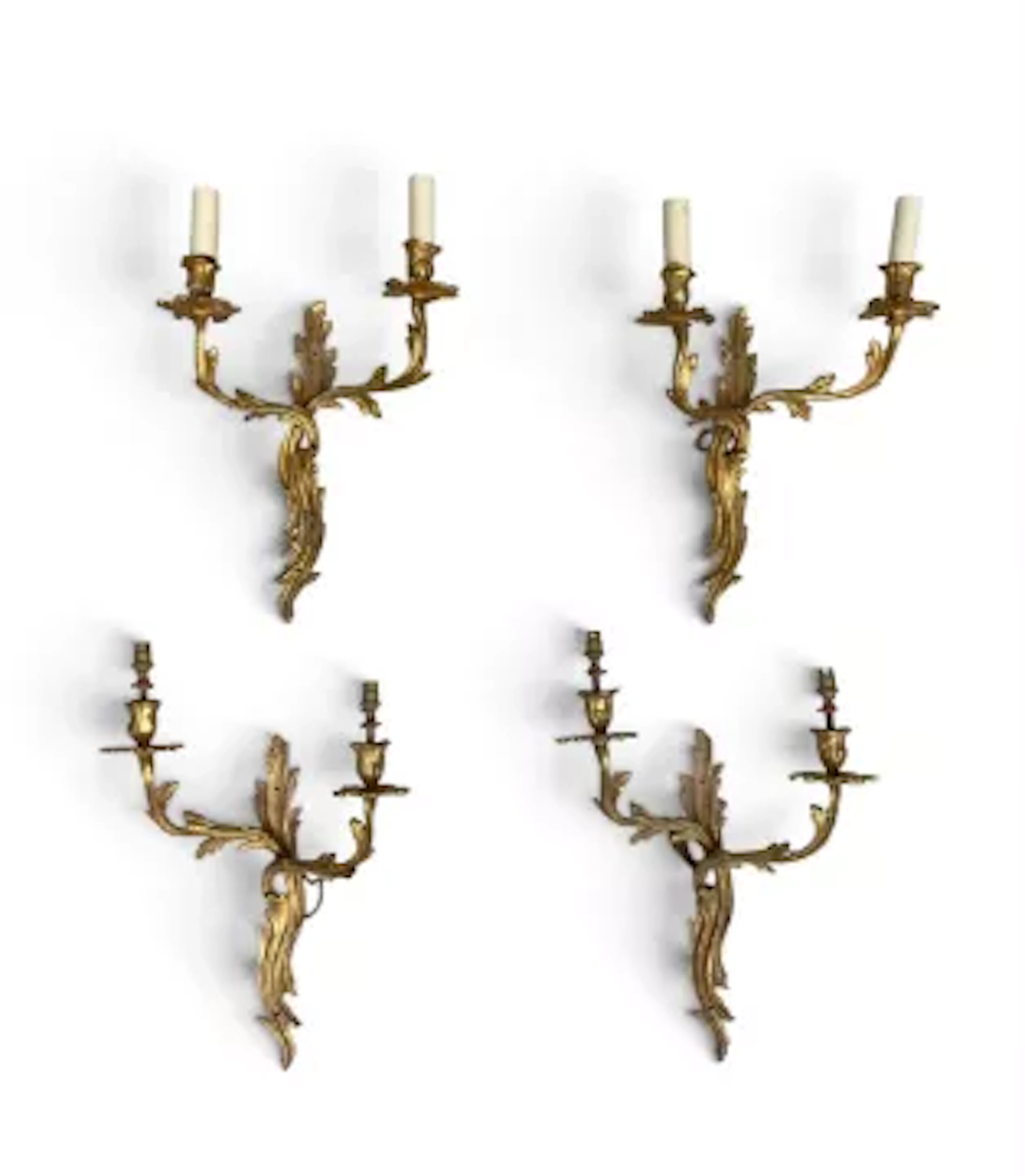 A set of four vintage gilt metal twin branch wall sconces in the Rococo