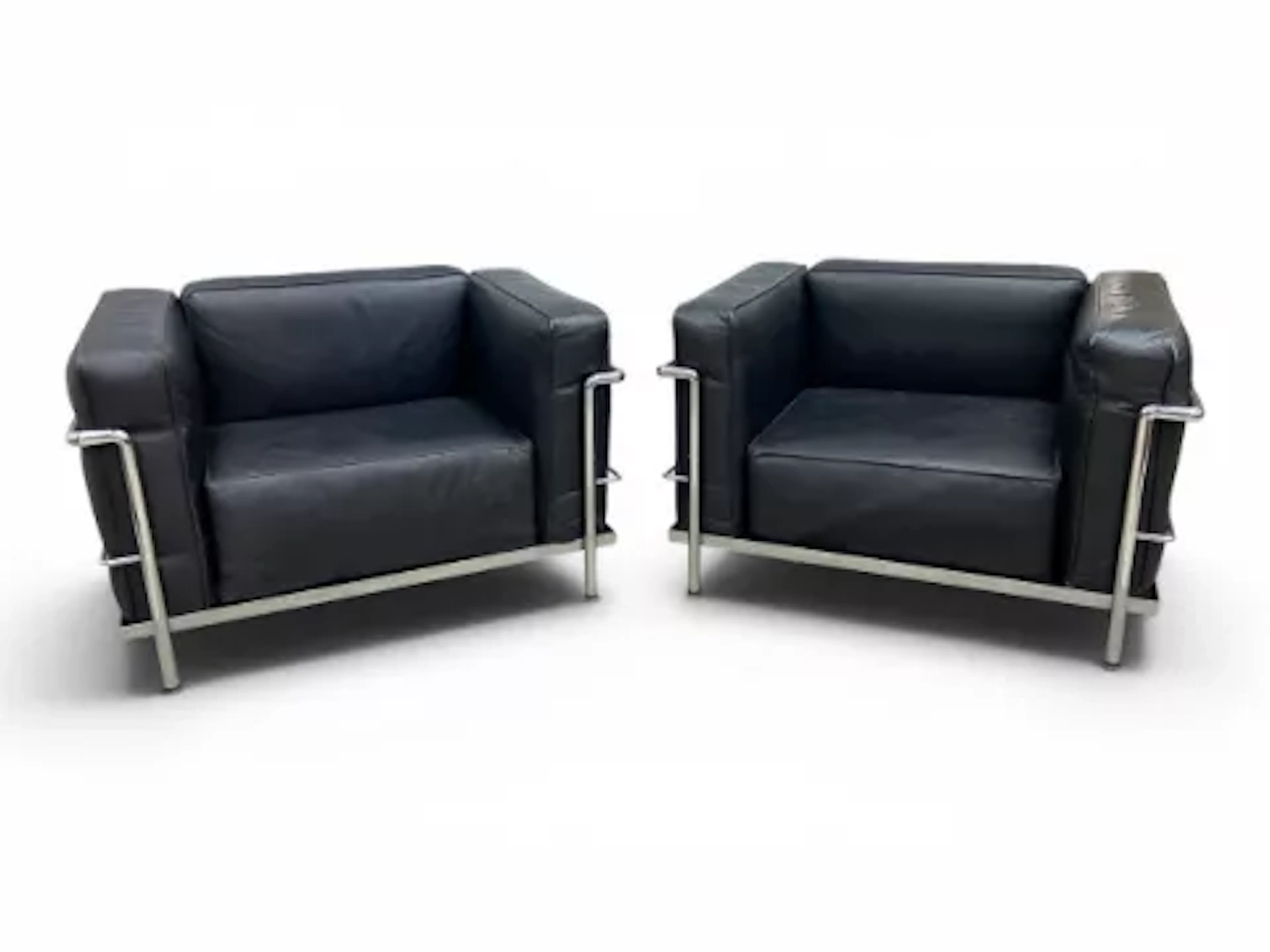 A pair of vintage black leather upholstered LC3 Grand Confort fauteuil