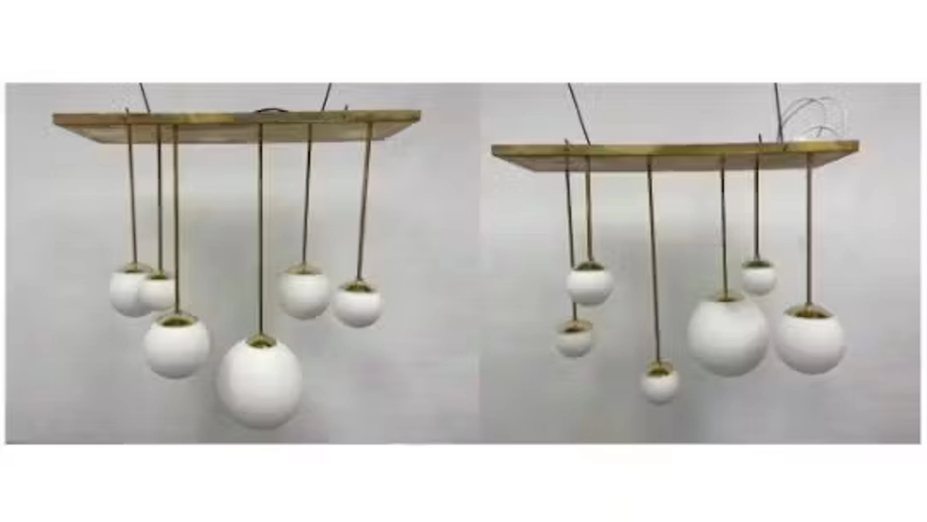 A pair of mid-century vintage brass chandeliers with white glass globe