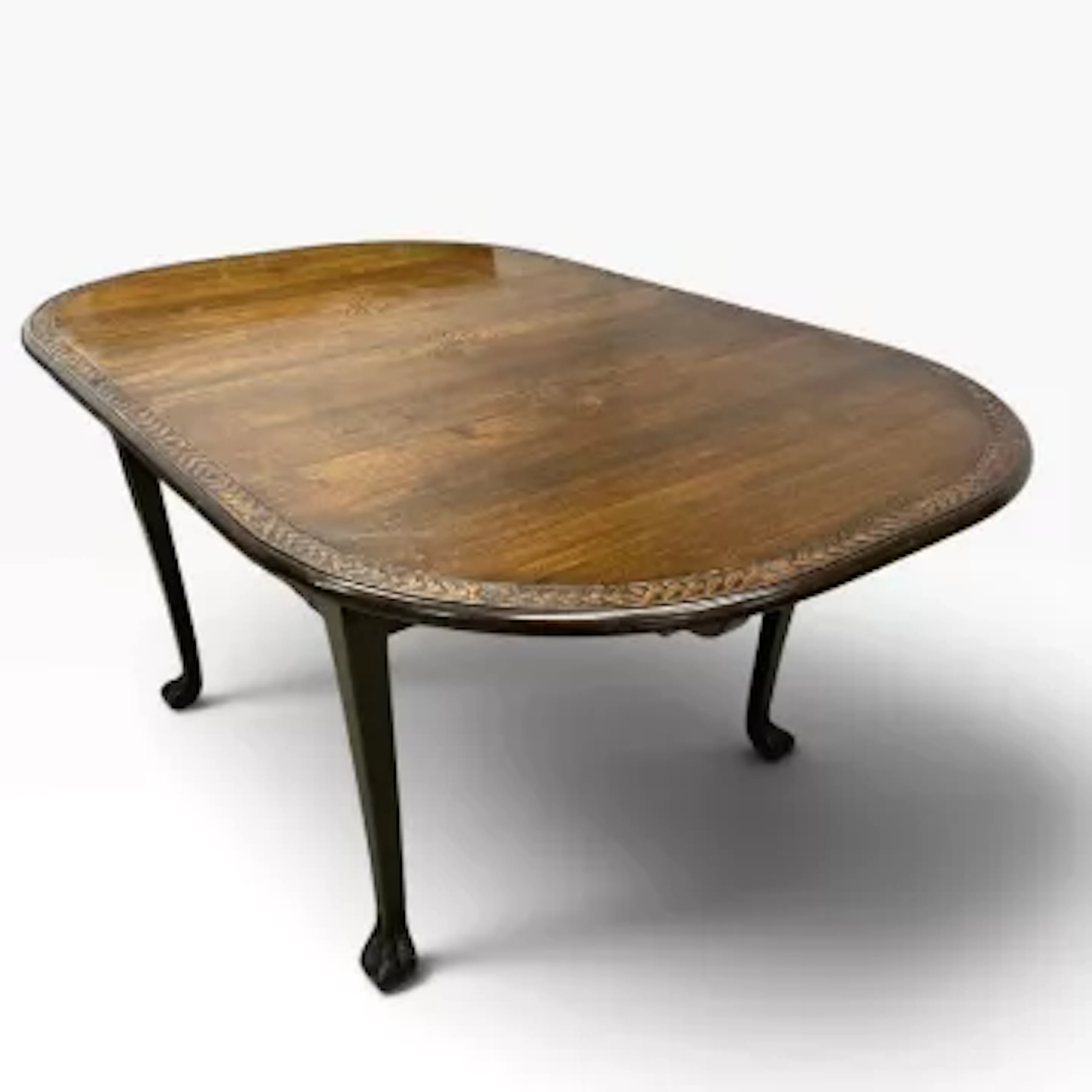 An early 20th century carved teak extending dining table with two