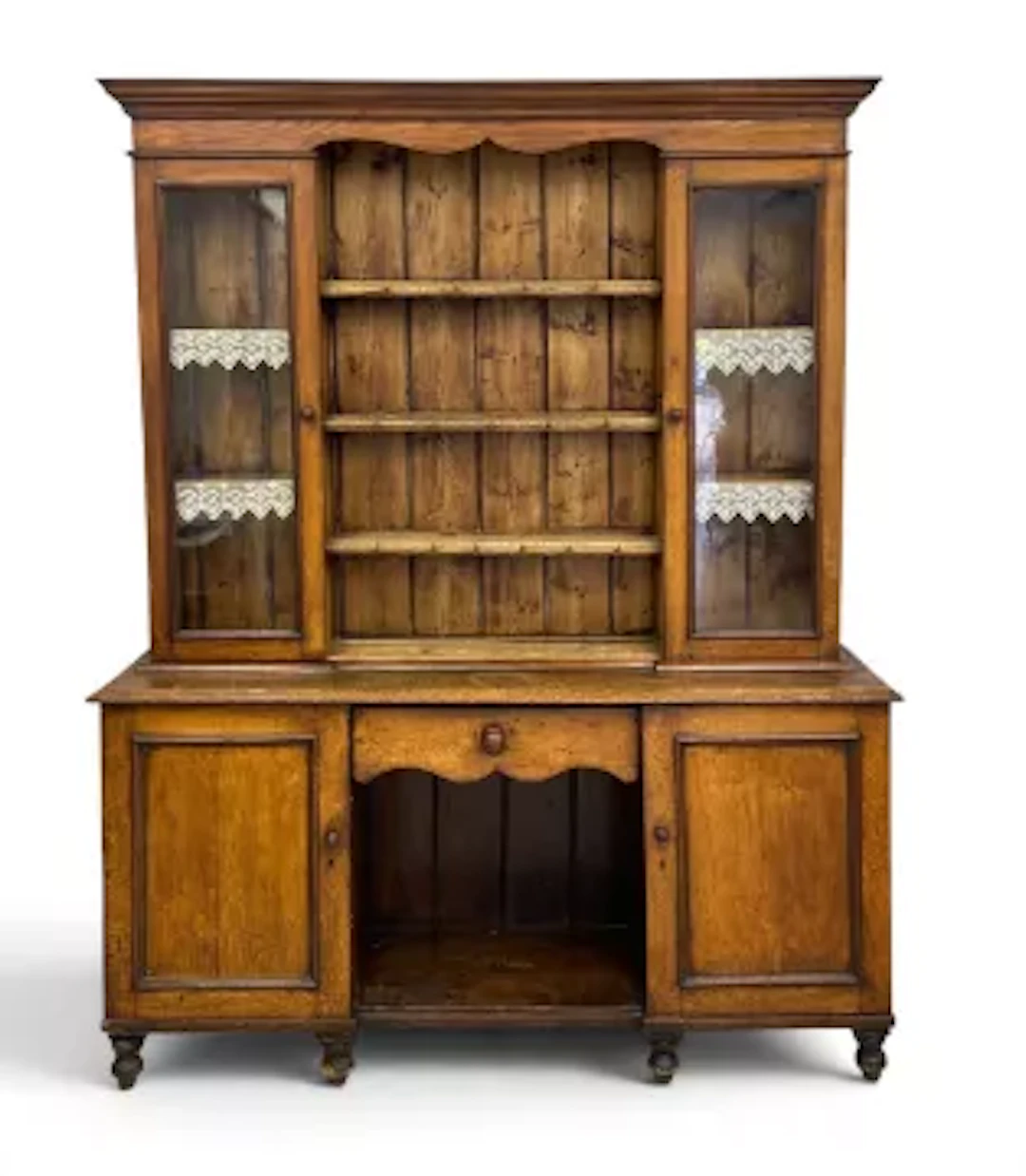 A Victorian oak dresser in two parts, the upper section with shelves