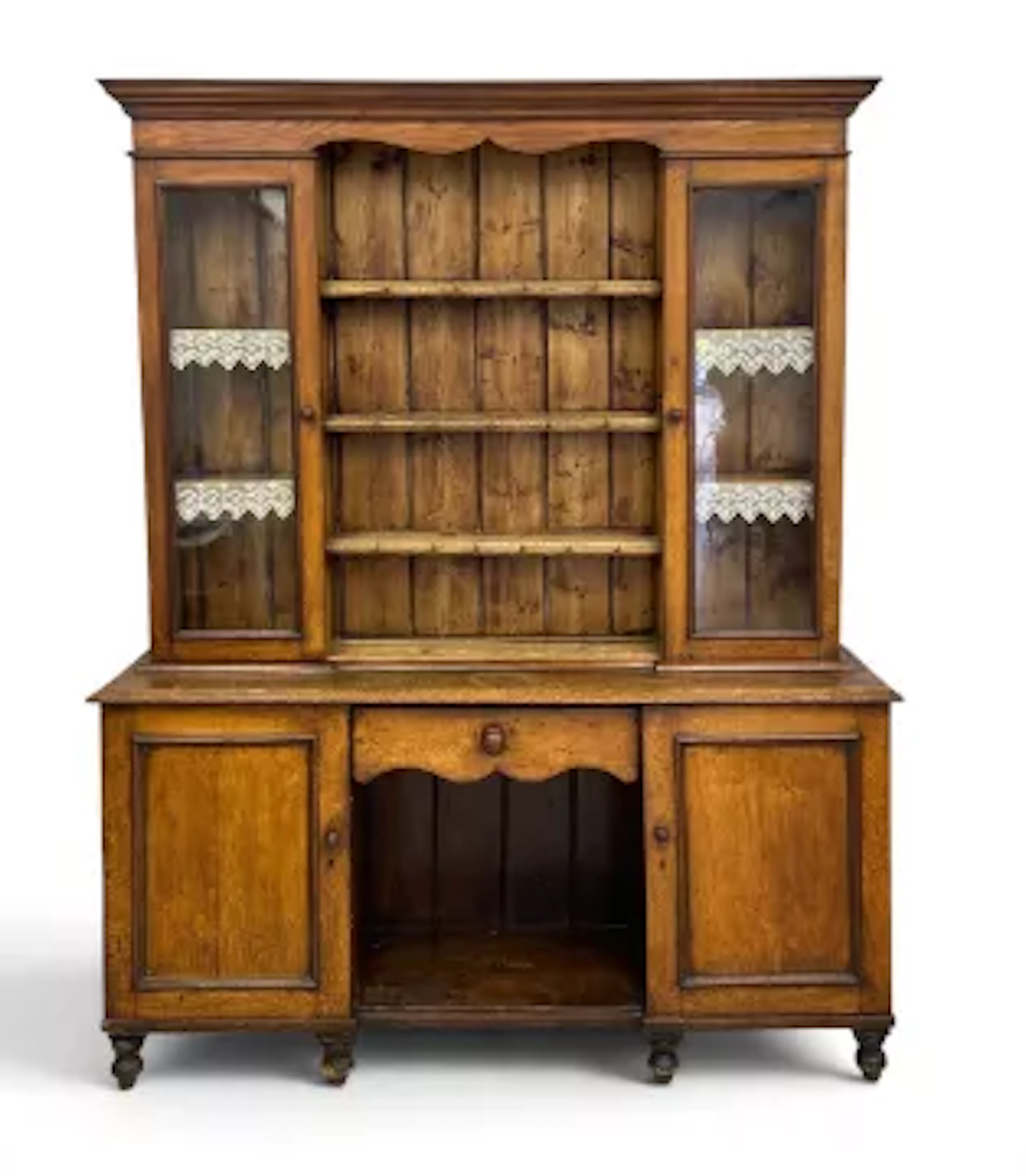 A Victorian oak dresser in two parts, the upper section with shelves