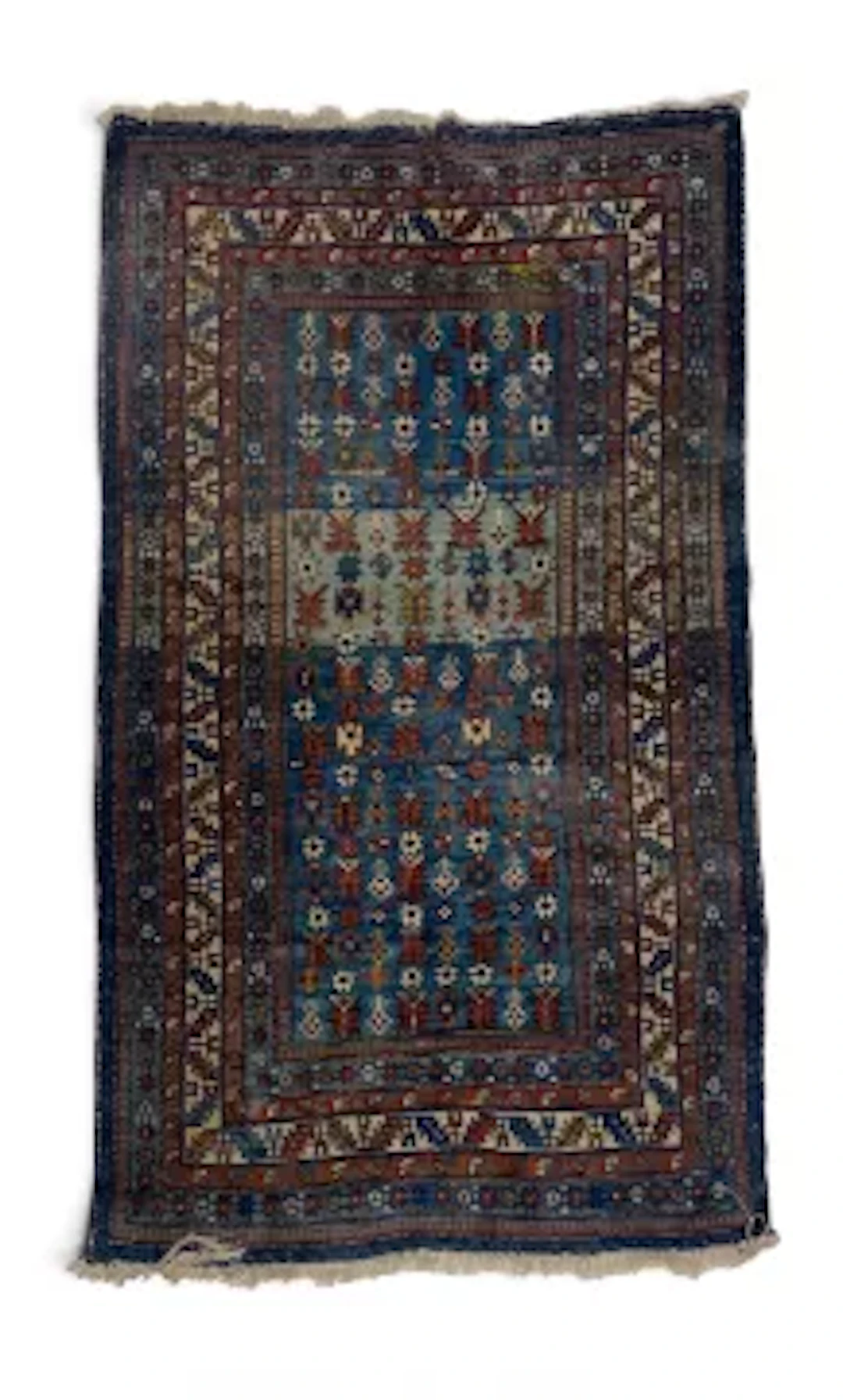 A hand woven Eastern carpet with repeating flowerhead motifs on a