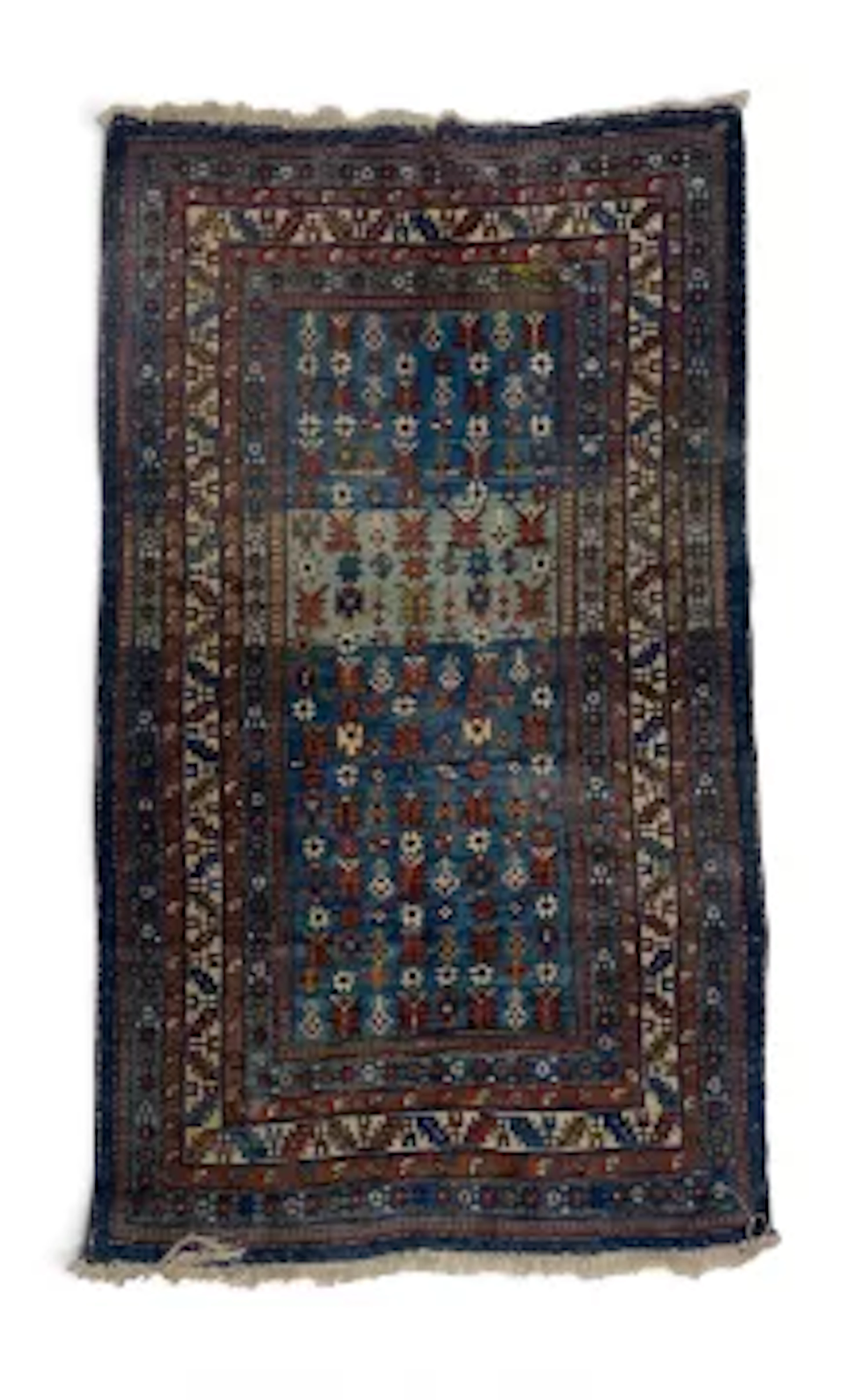 A hand woven Eastern carpet with repeating flowerhead motifs on a