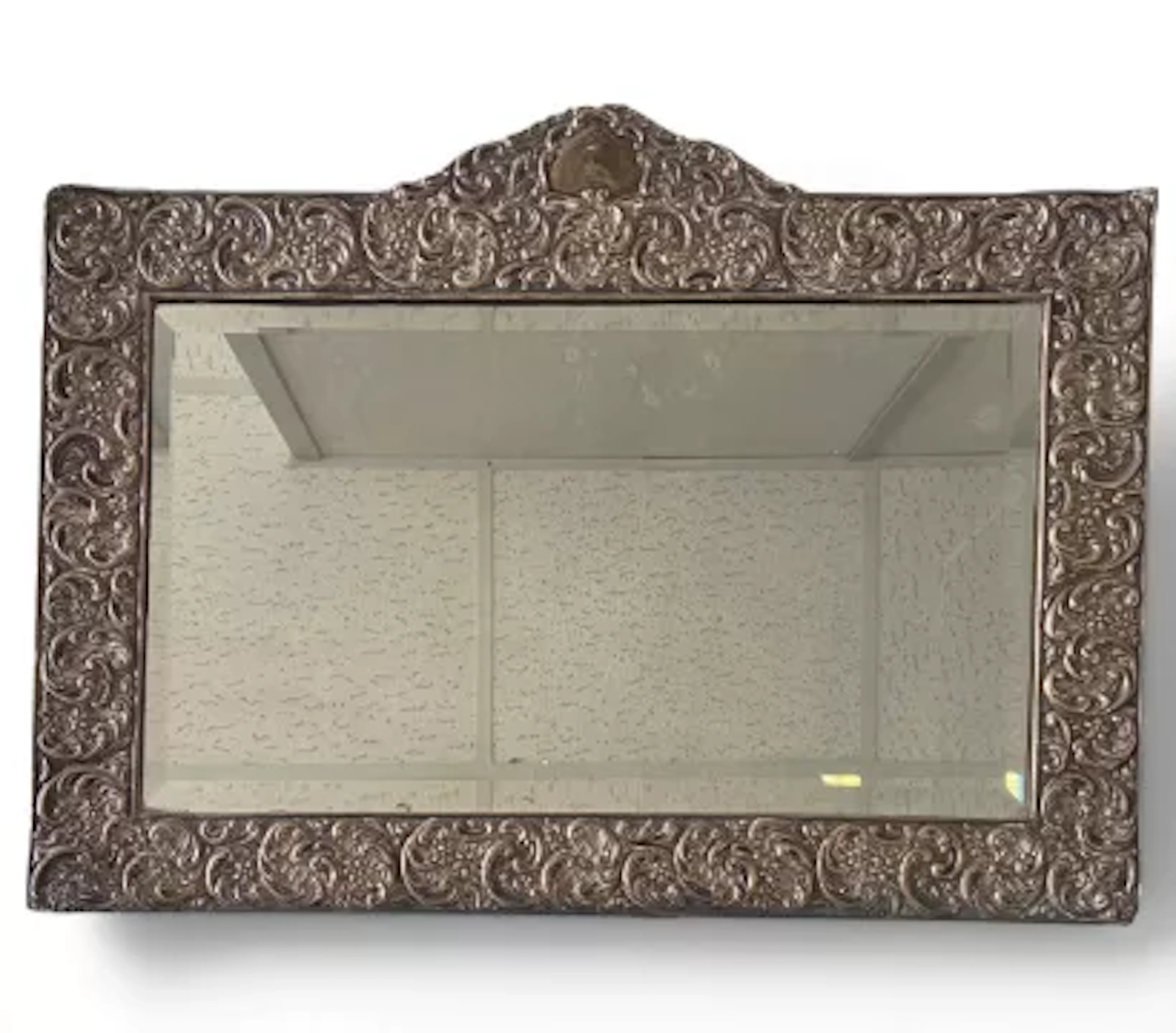 A 19th century embossed white metal wall mirror with bevelled plate.