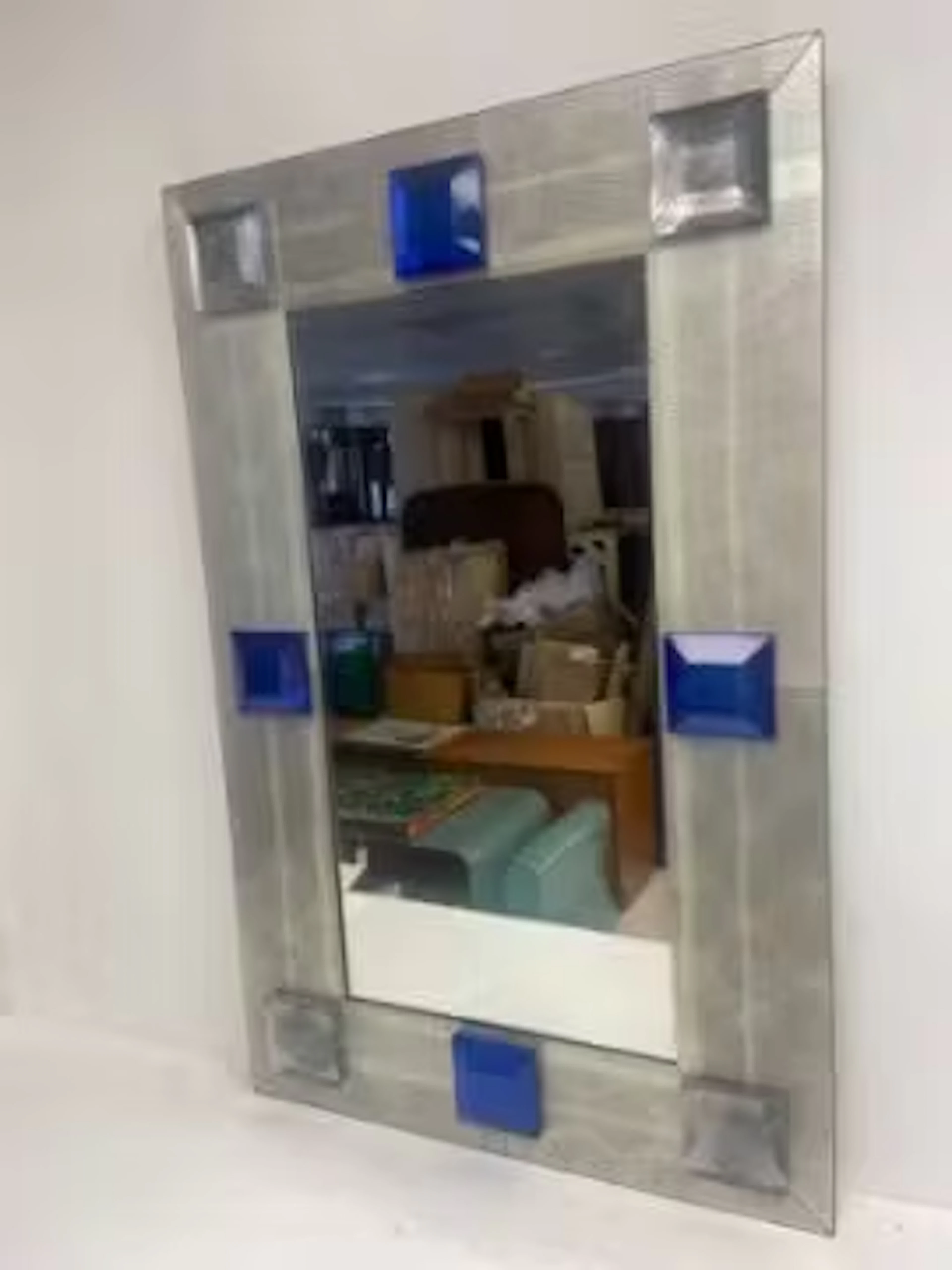 A mid-century Italian wall mirror in hand-hammered Venetian glass.
