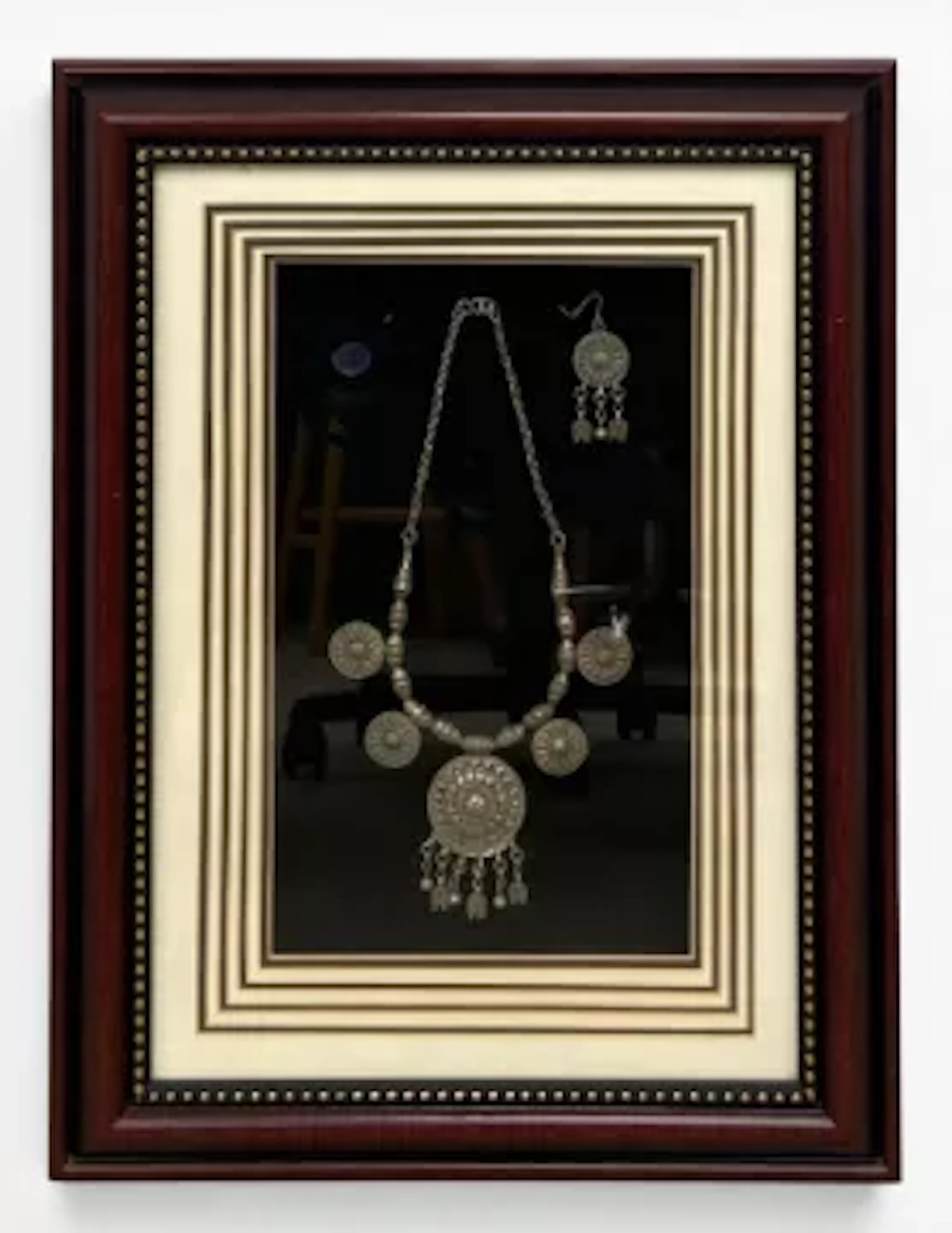 A vintage tribal style white metal necklace and earring set in a glazed