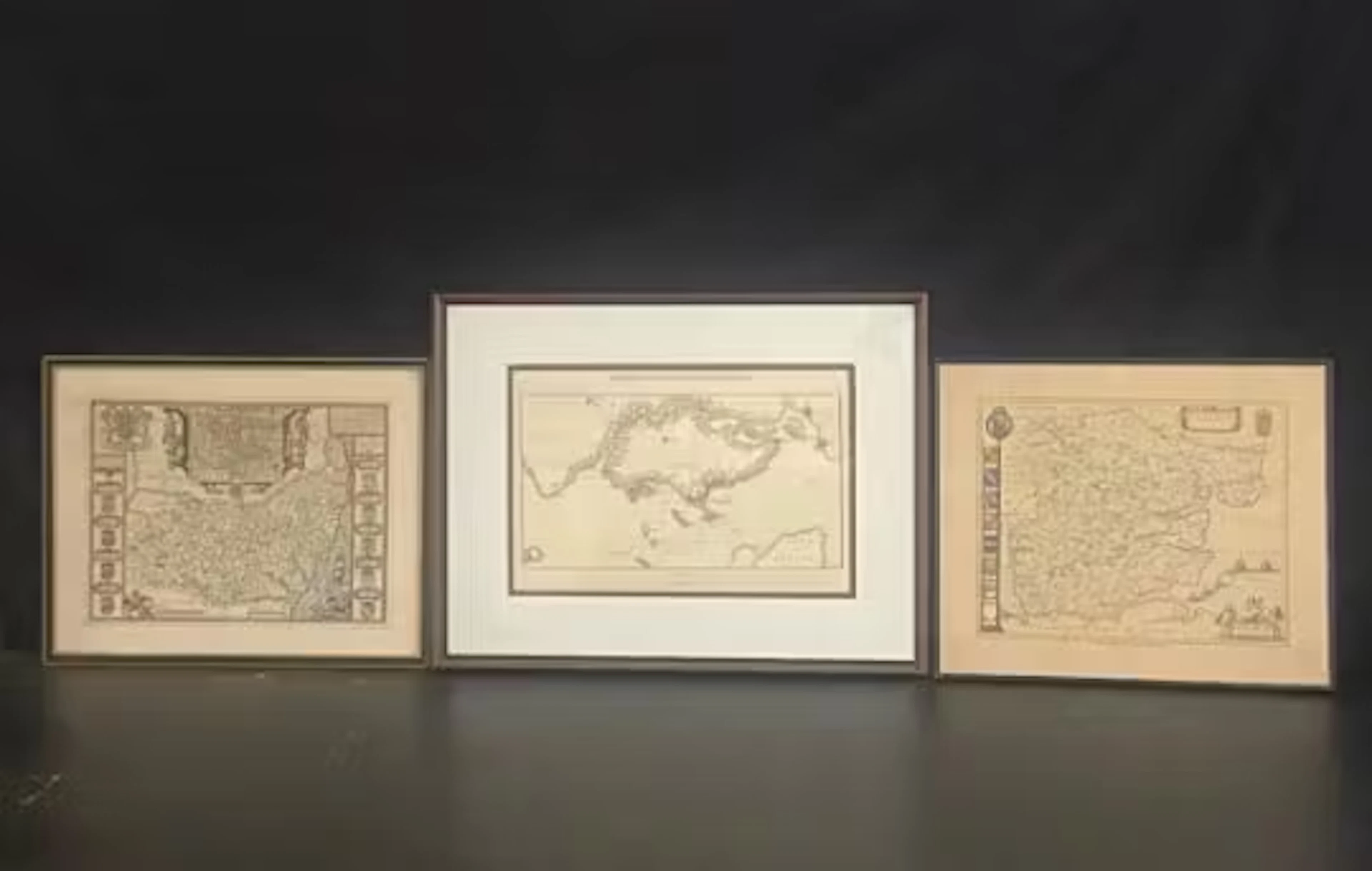 A collection of three framed and glazed maps, to include Suffolk