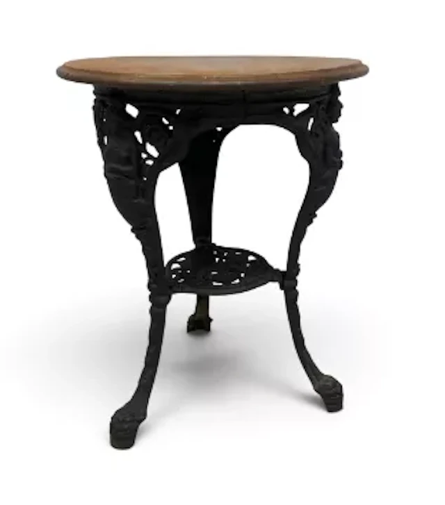 A Victorian style cast iron Britannia pub table with a circular top