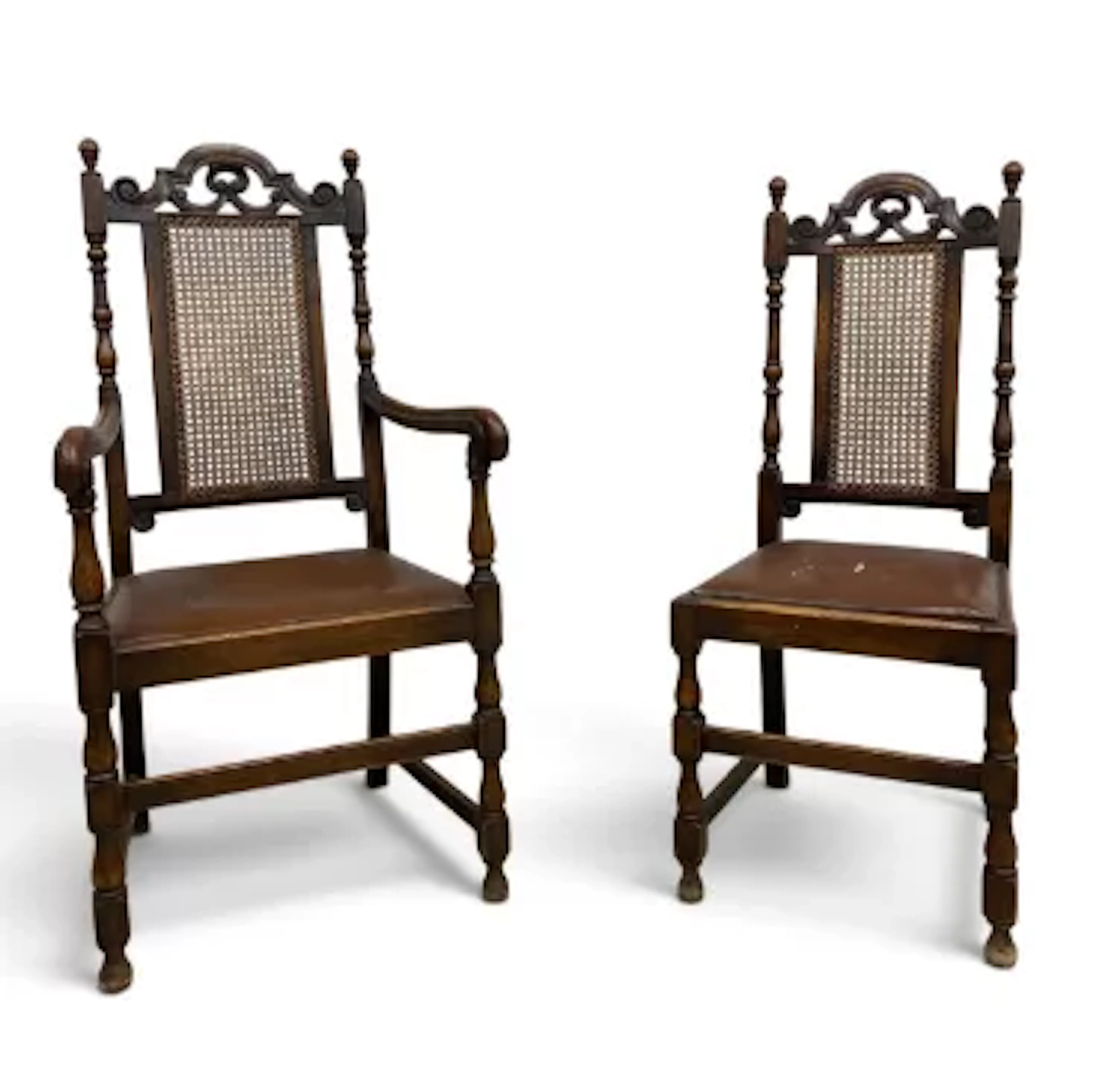 A set of six Carolean style oak dining chairs each having a carved