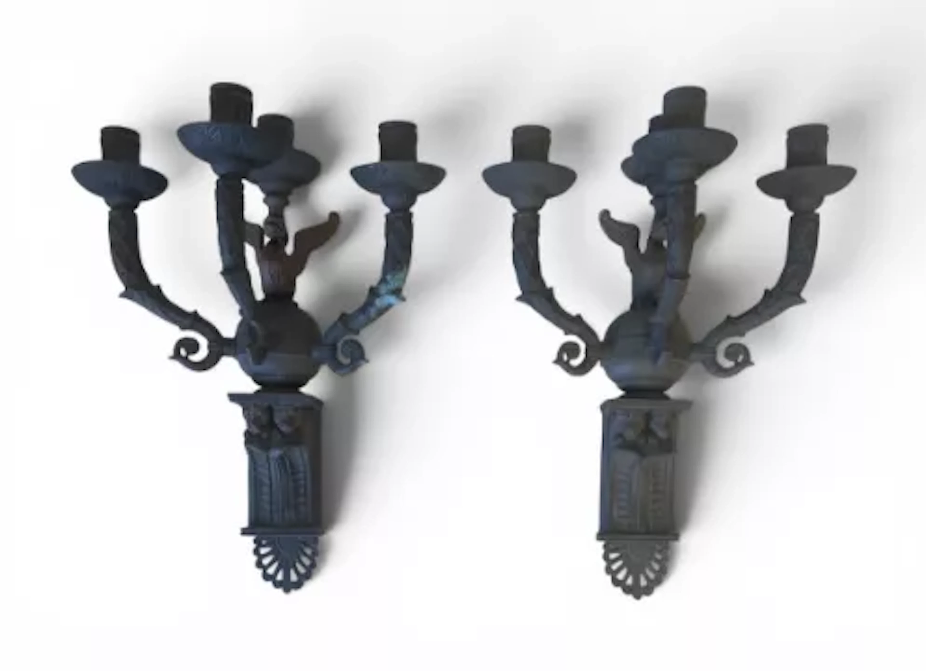 A pair of Gothic style four-branch cast iron wall sconces each with