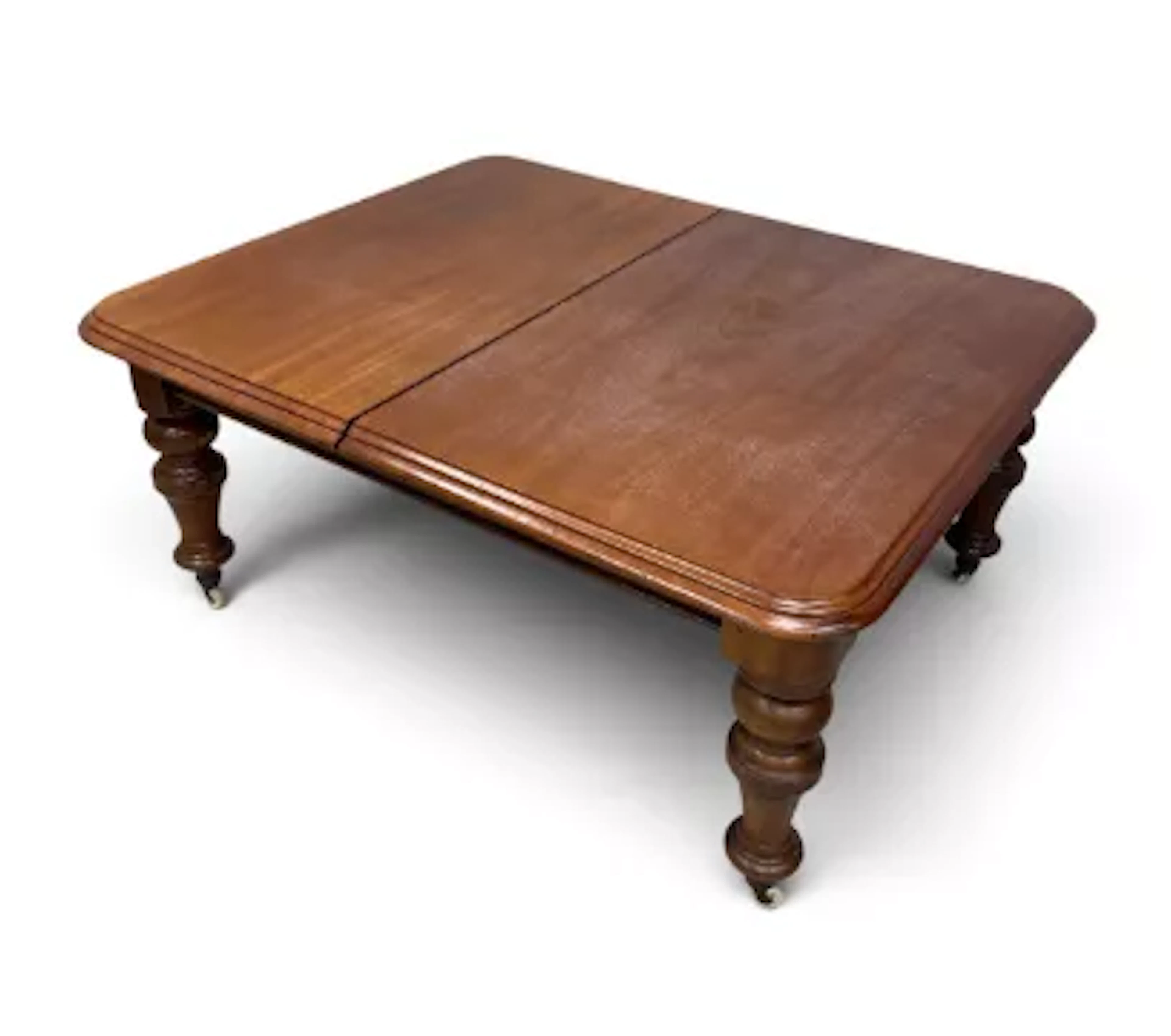 A 19th century mahogany extending dining table with turned legs on