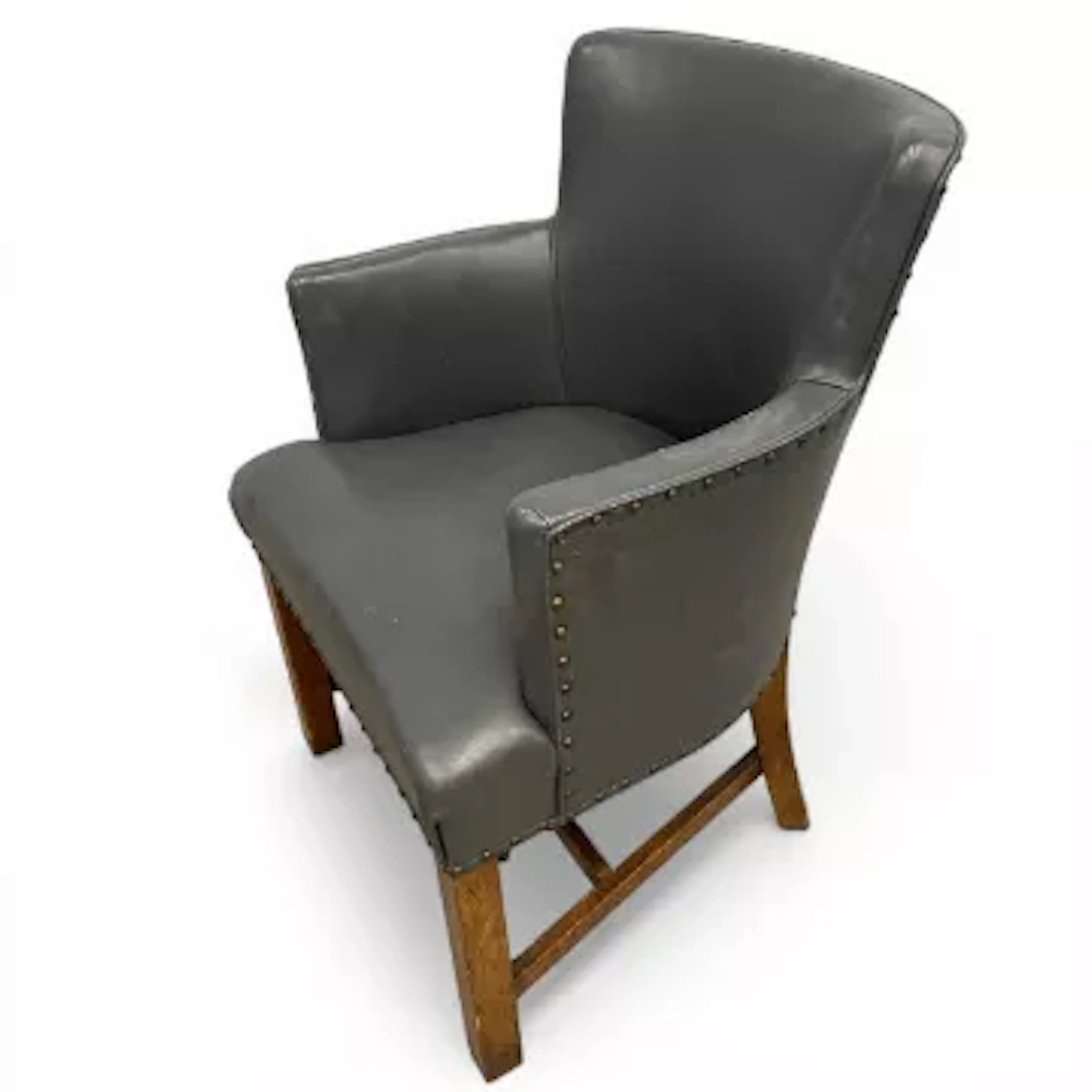 A pair of vintage tub chairs each having a curved back and arms over