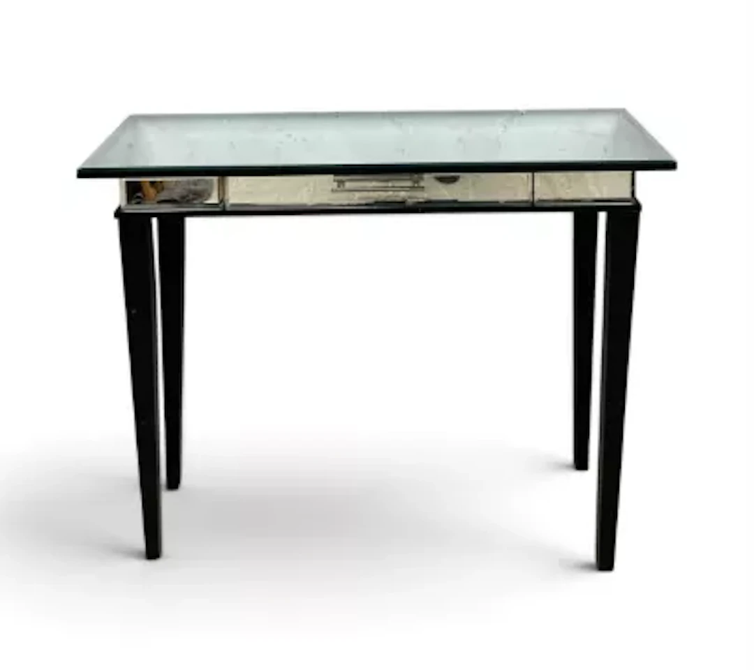 A small mirrored side table or console with with frieze drawer on