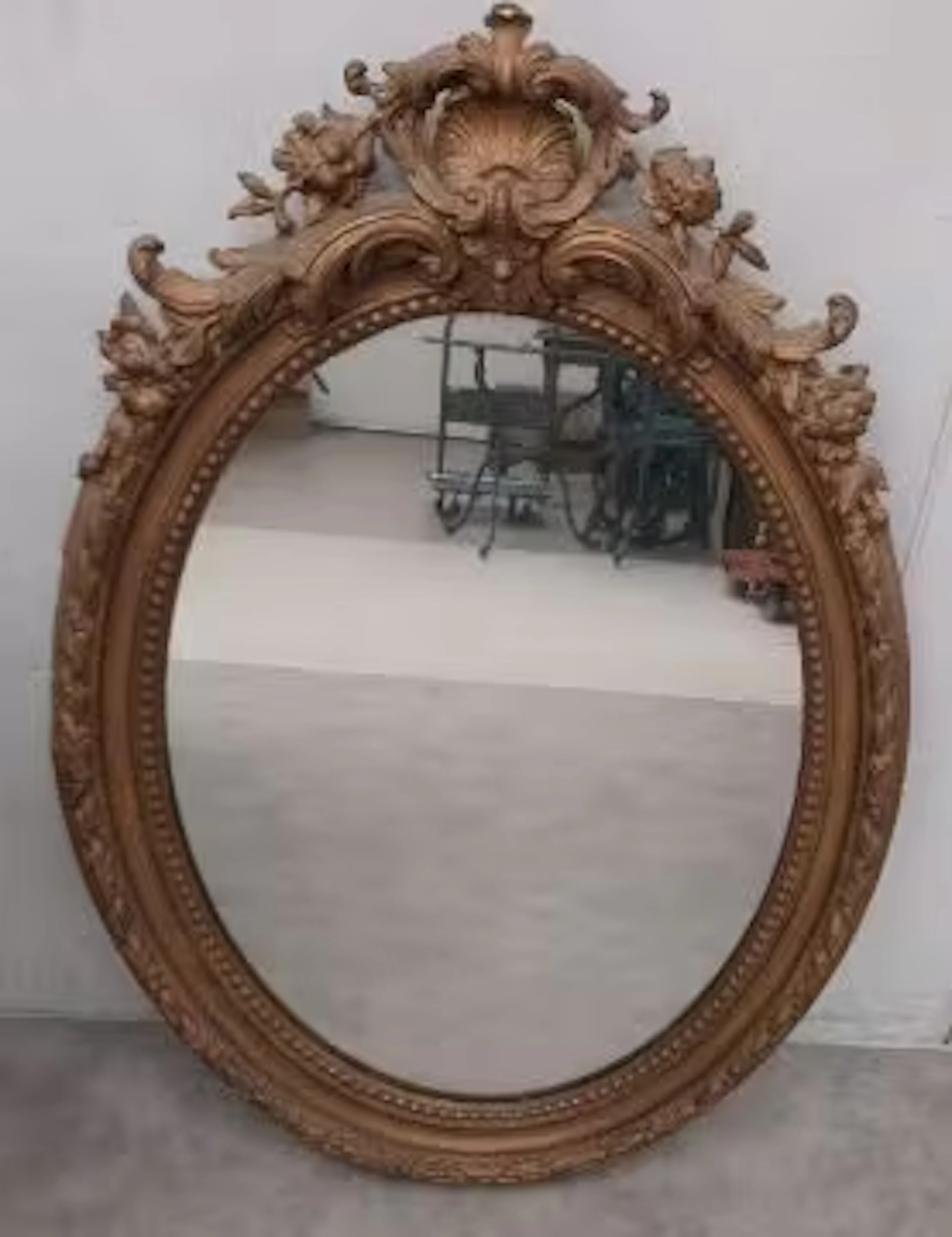 A 19th century wall mirror in a giltwood and gesso frame with scrolling