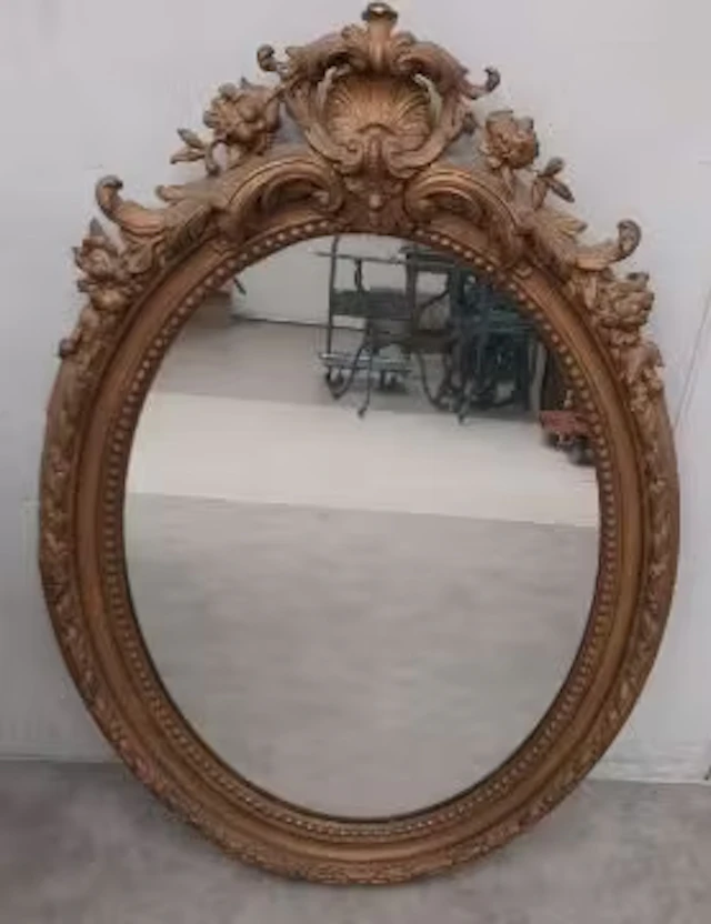 A 19th century wall mirror in a giltwood and gesso frame with scrolling