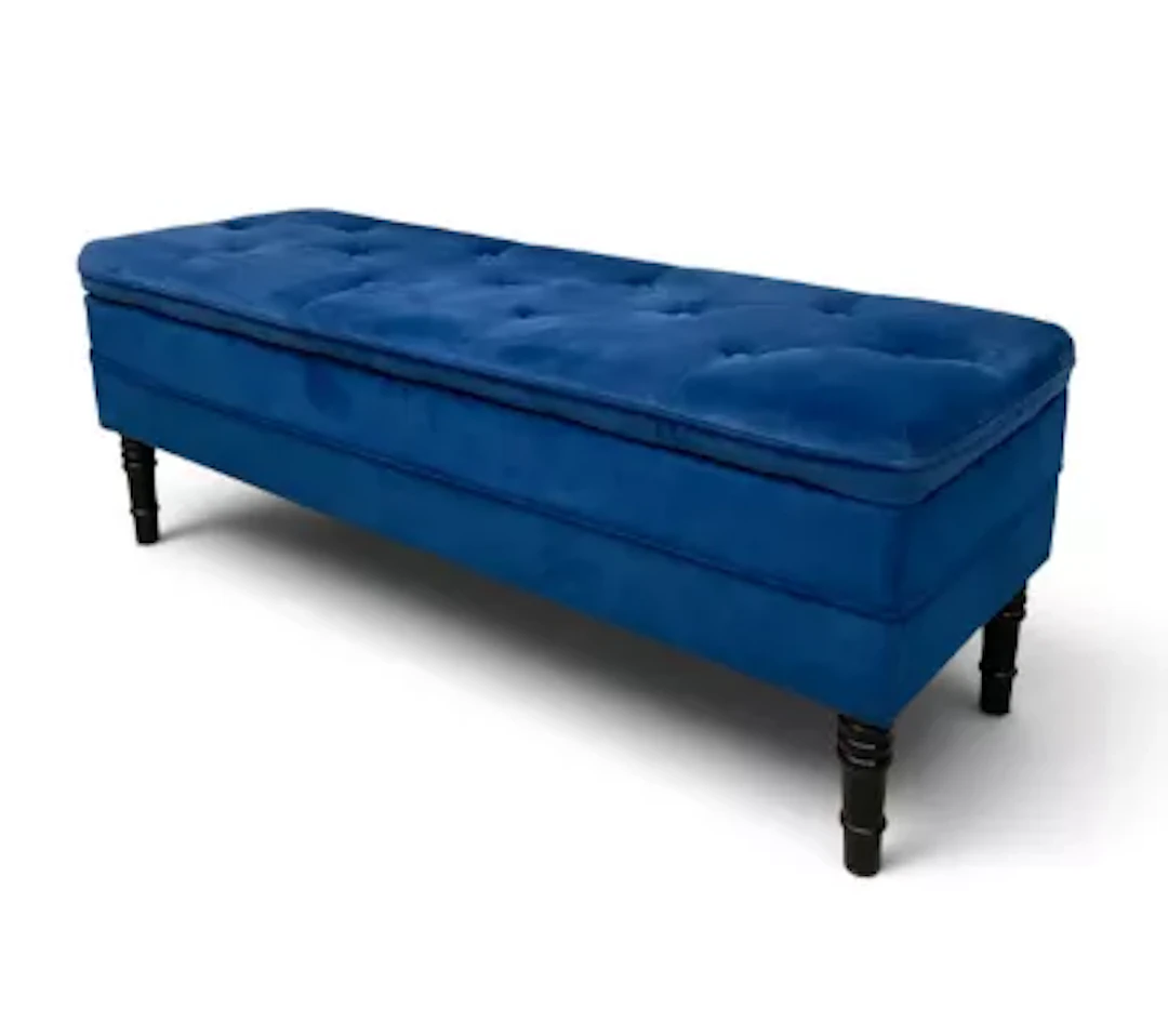 A contemporary ottoman footstool with hinged top in deep buttoned