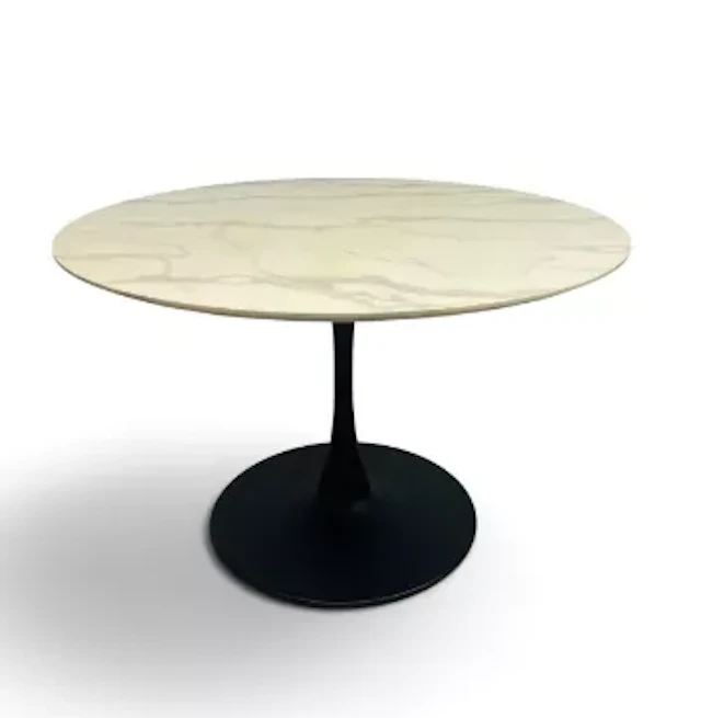 A retro styled dining table with circular faux marble top and black