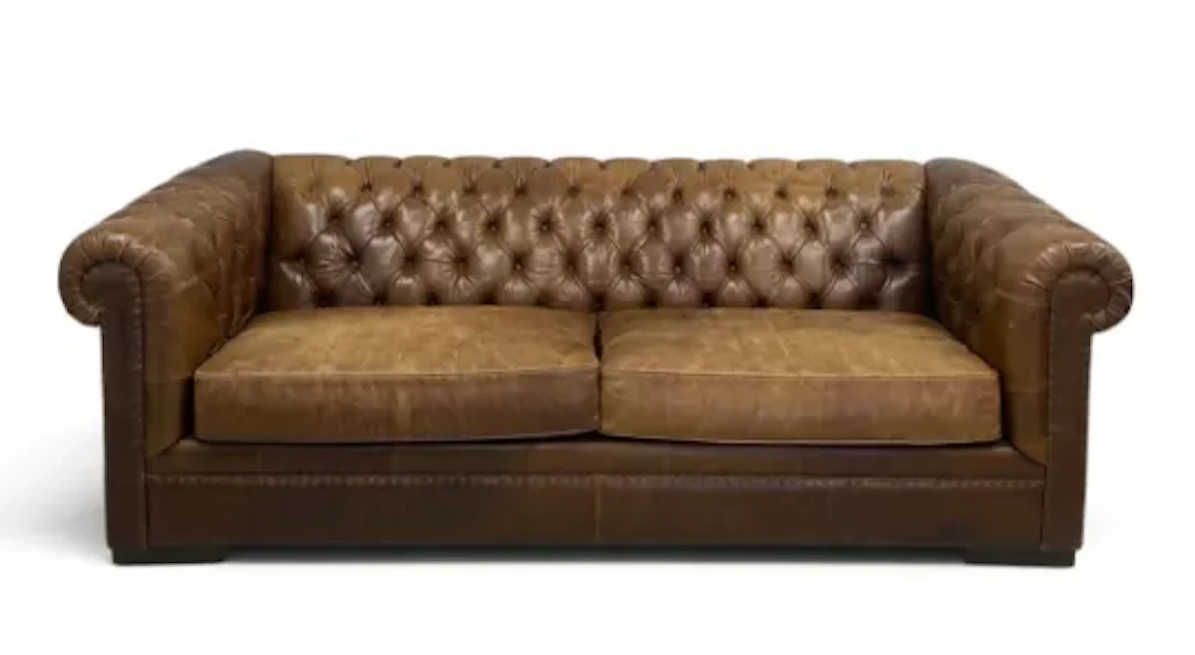 A contemporary brown leather upholstered chesterfield sofa with two