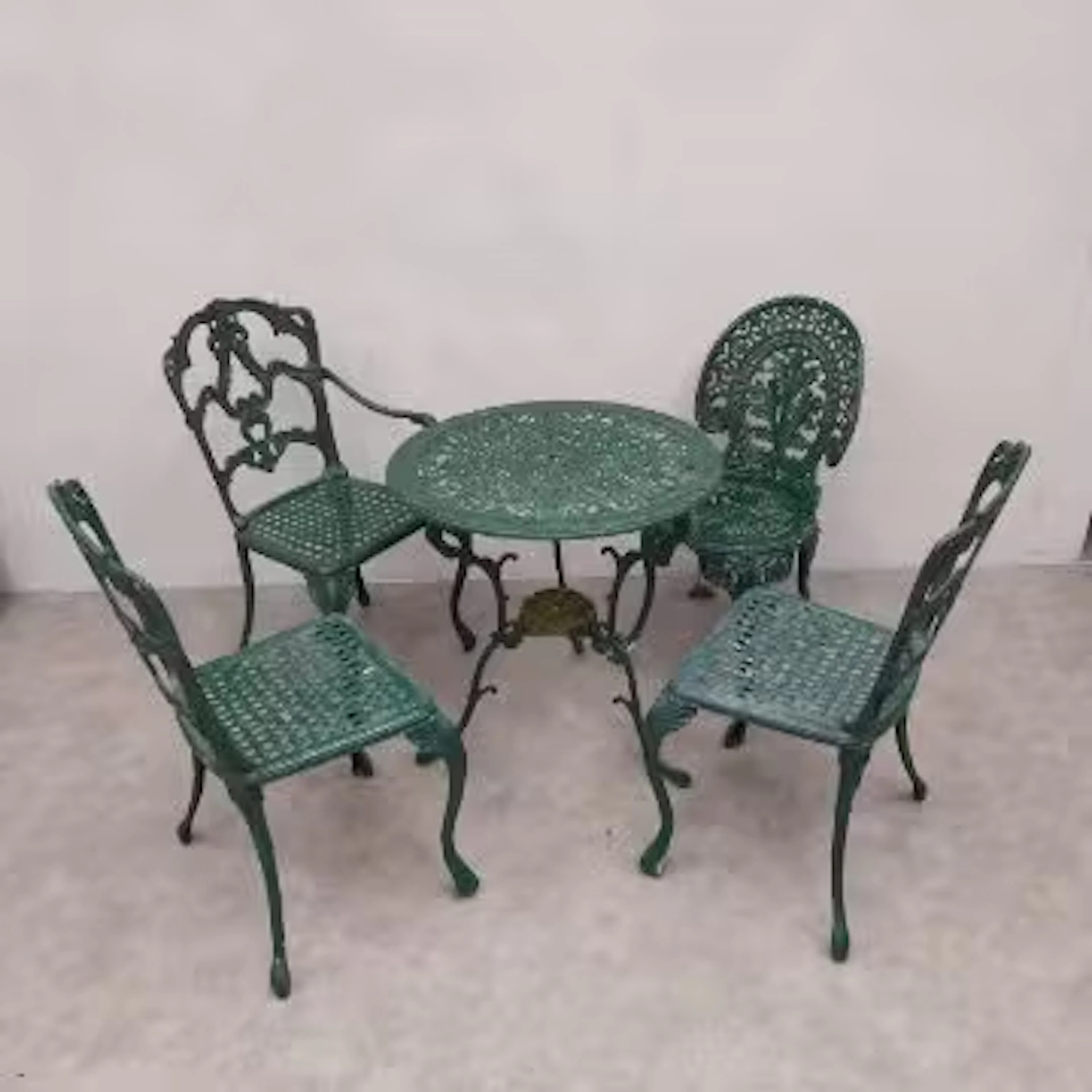 A 19th century style painted aluminium garden table and four similar