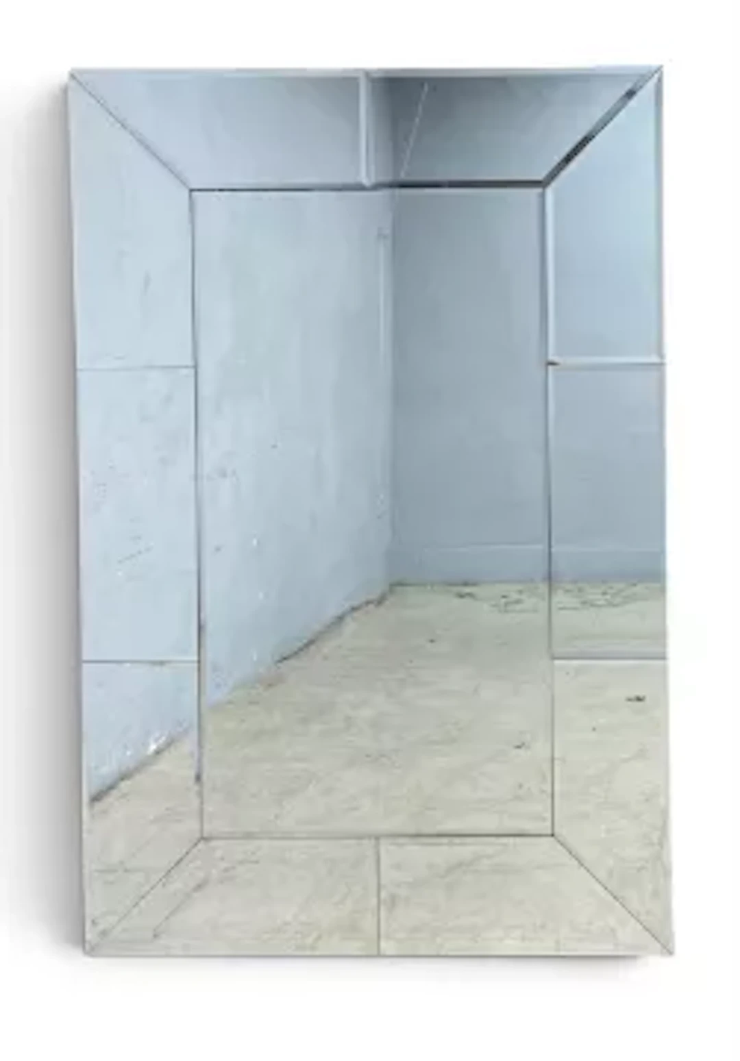 A very large contemporary wall mirror with bevelled plate in a glazed