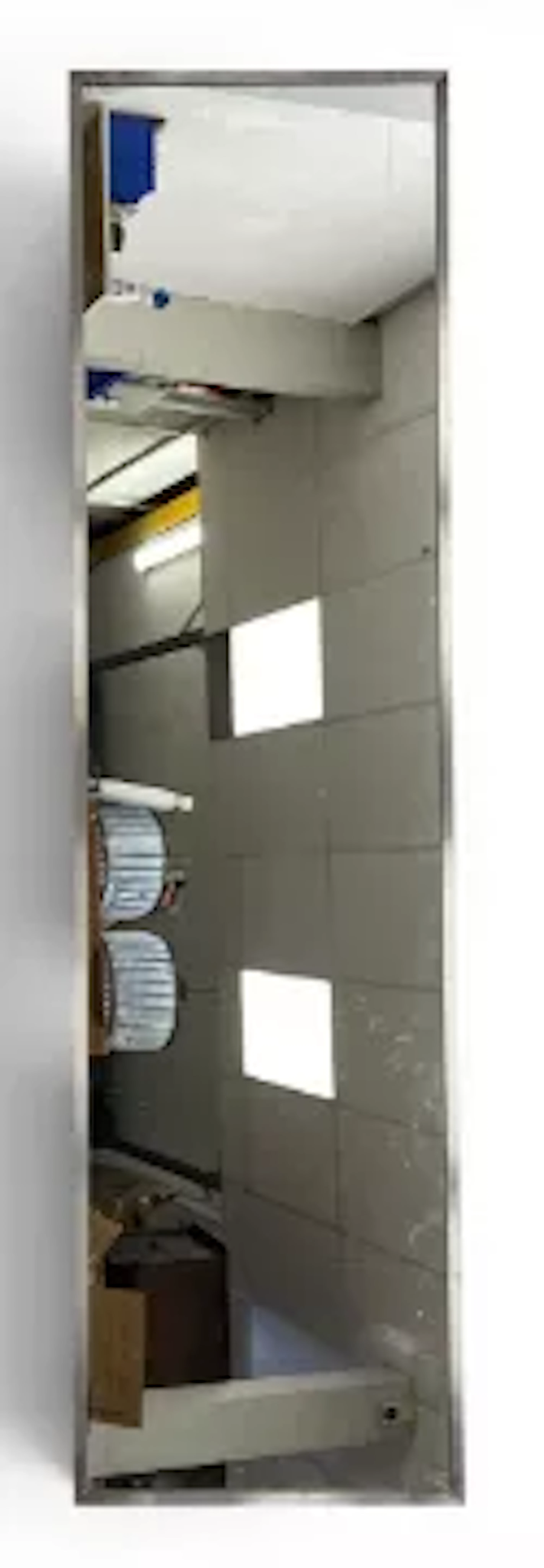 A very large contemporary floor mirror with a rectangular plate in