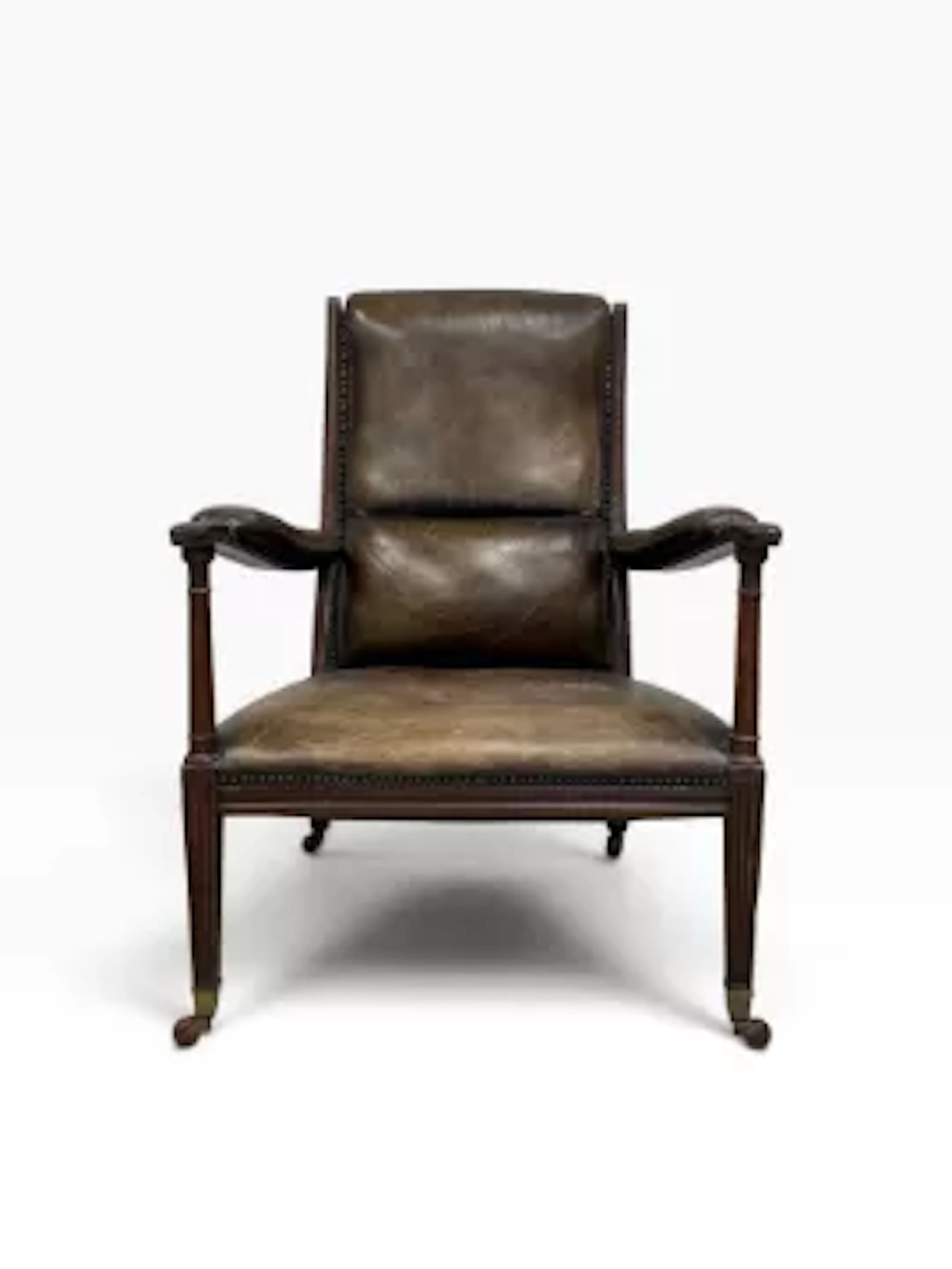 A 19th century mahogany open arm library armchair in studded leather