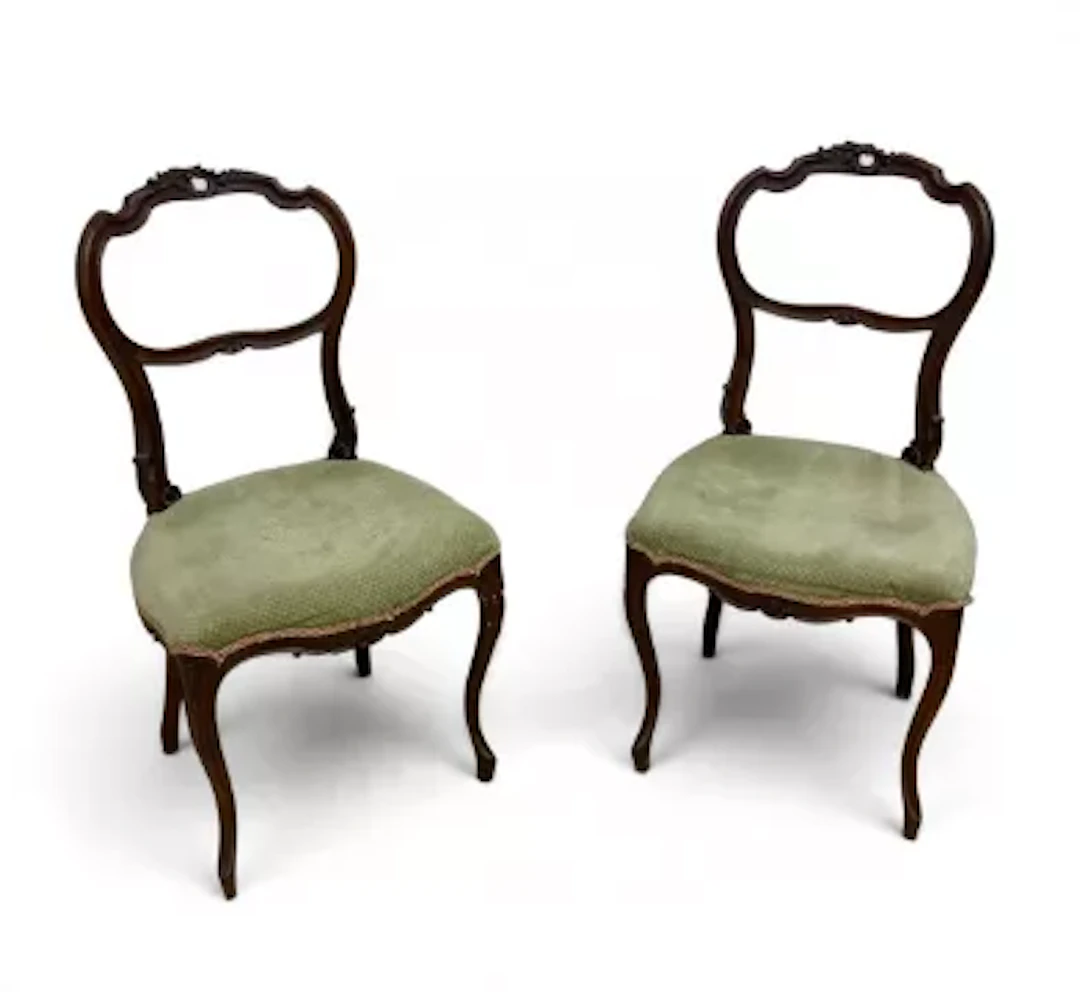 A pair of 19th century walnut carved and shaped back dining chairs