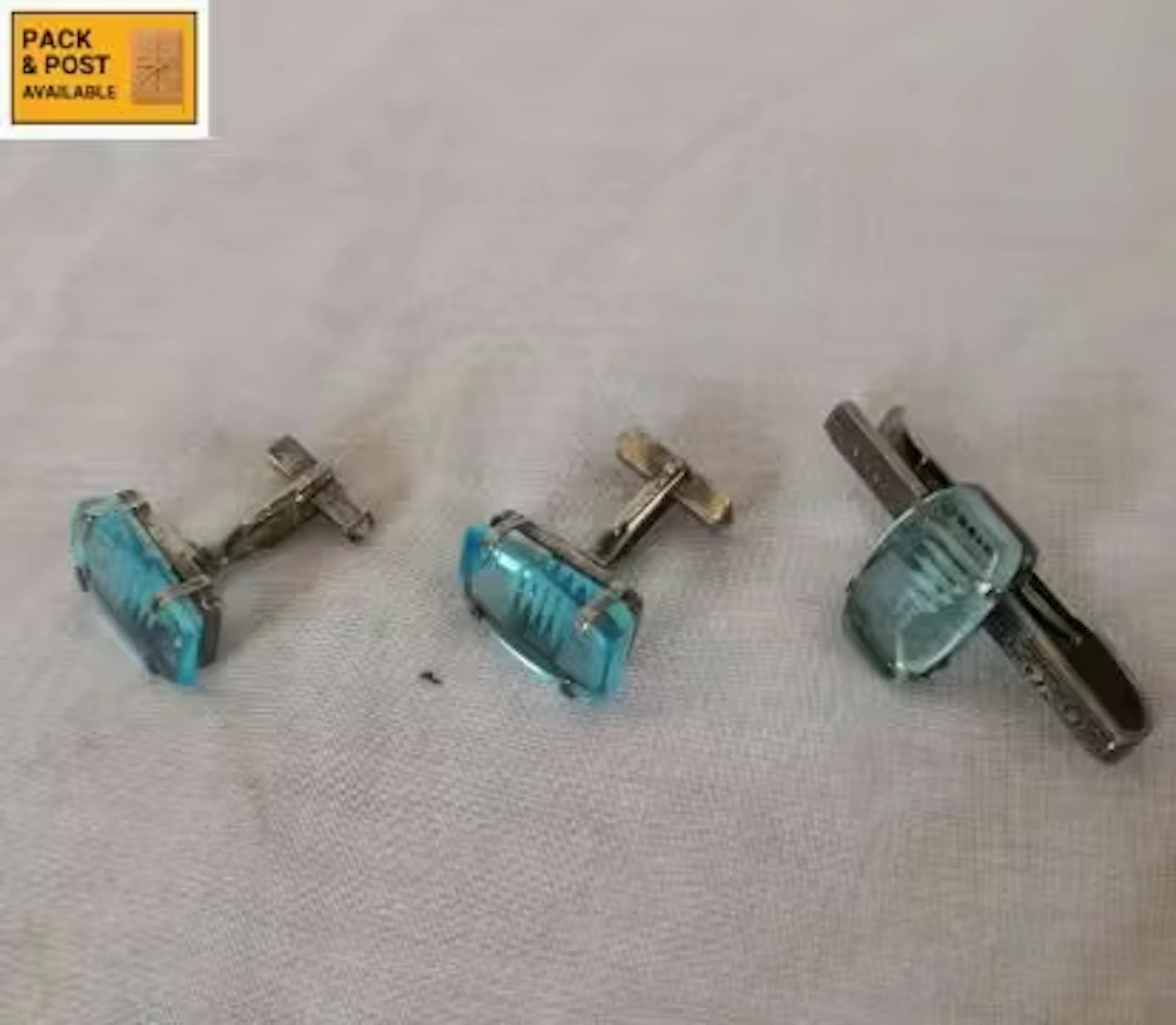 A gentlemen's silver and blue topaz tie pin and cufflinks set with