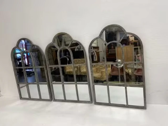 A set of three Regency style architectural garden mirrors in distressed