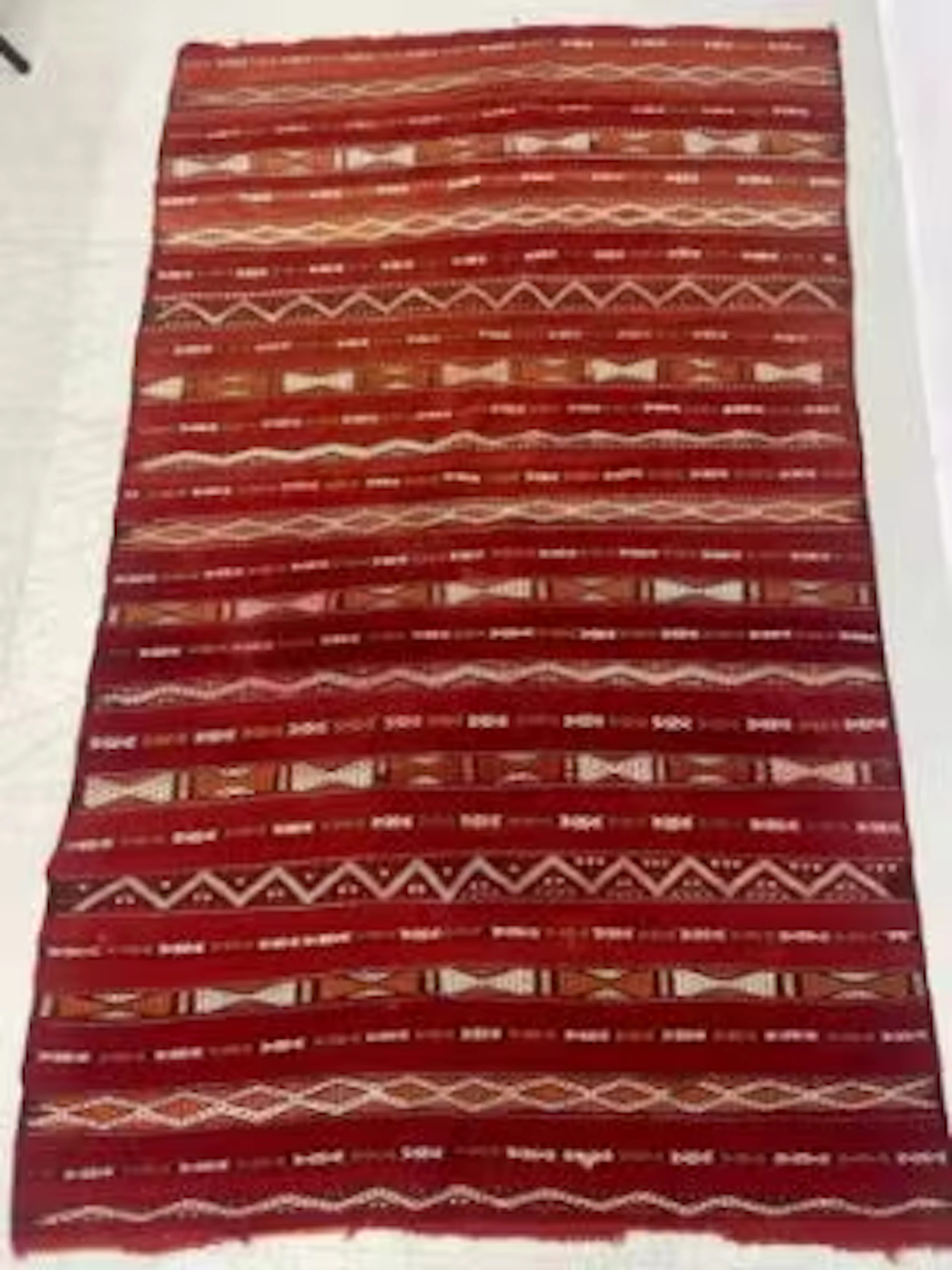 A large Morrocan Kilim carpet with bands of geometric decoration over