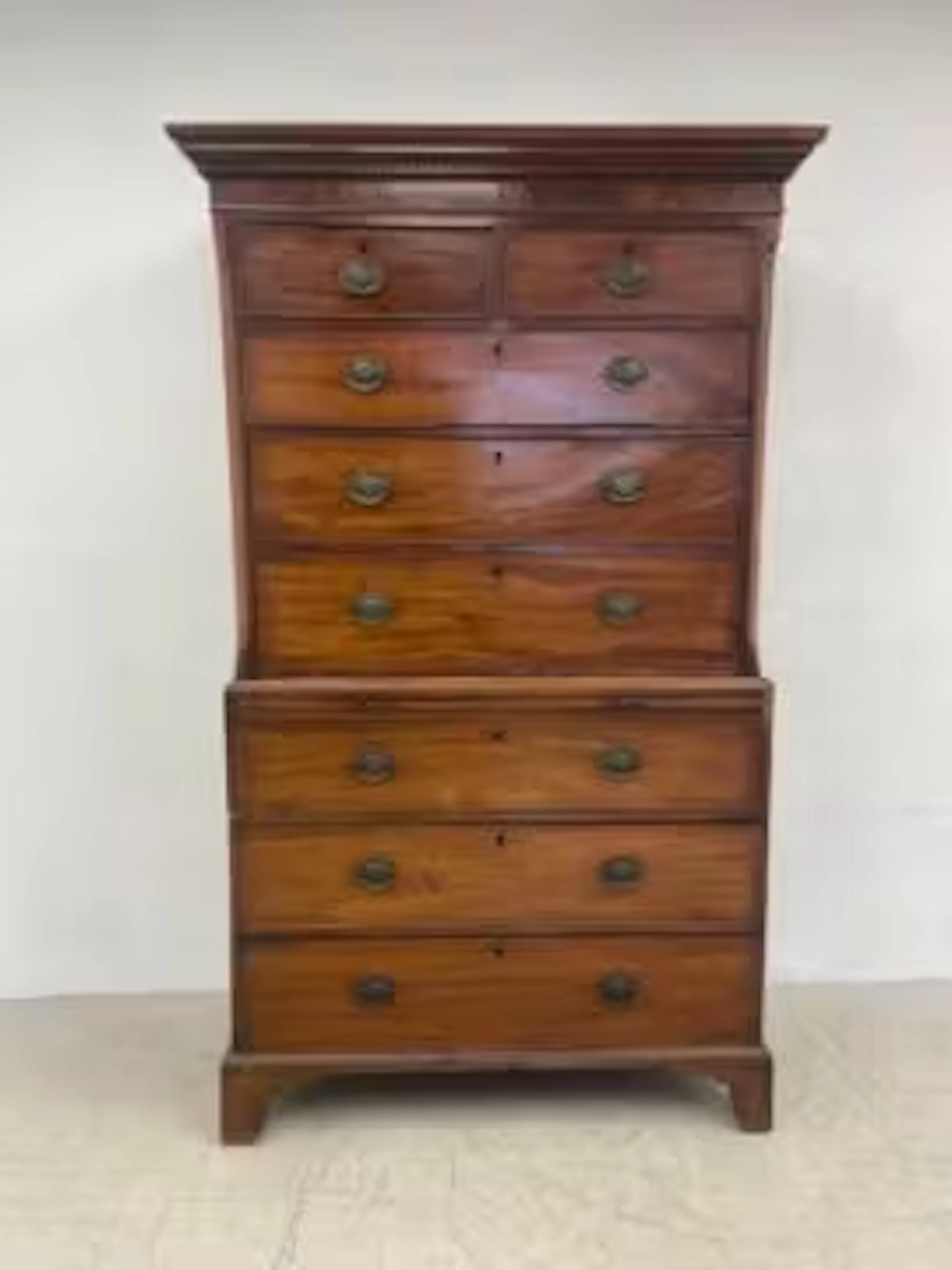 A Georgian mahogany chest on chest with Greek key carved cornice above