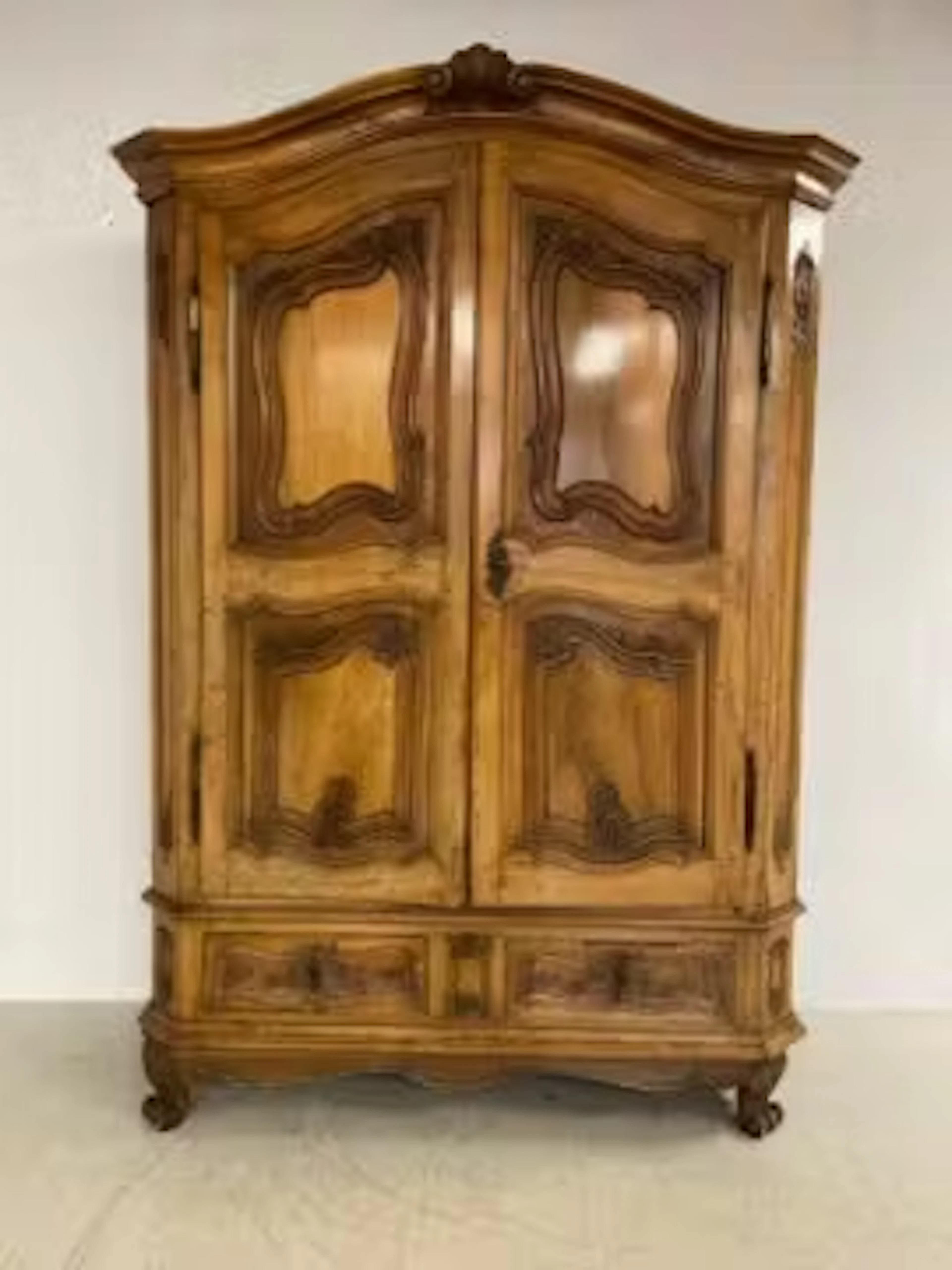 A 19th century chestnut armoire having a shaped and moulded pediment